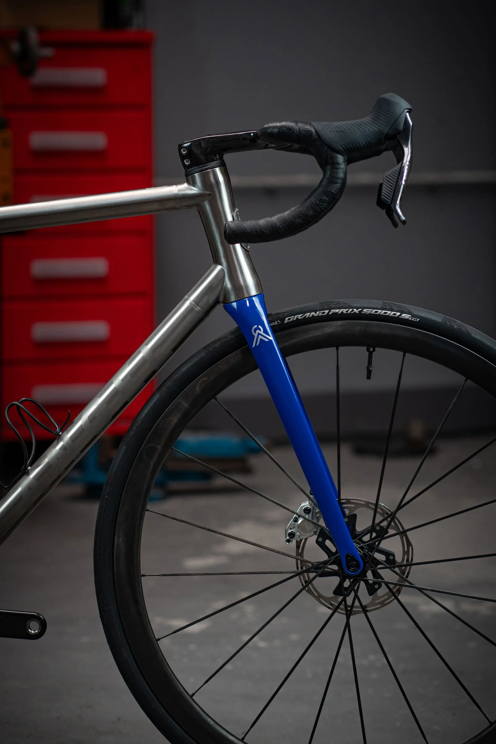 Titanium road bicycle with blue fork, photographed for ANGEL Cycle Works.