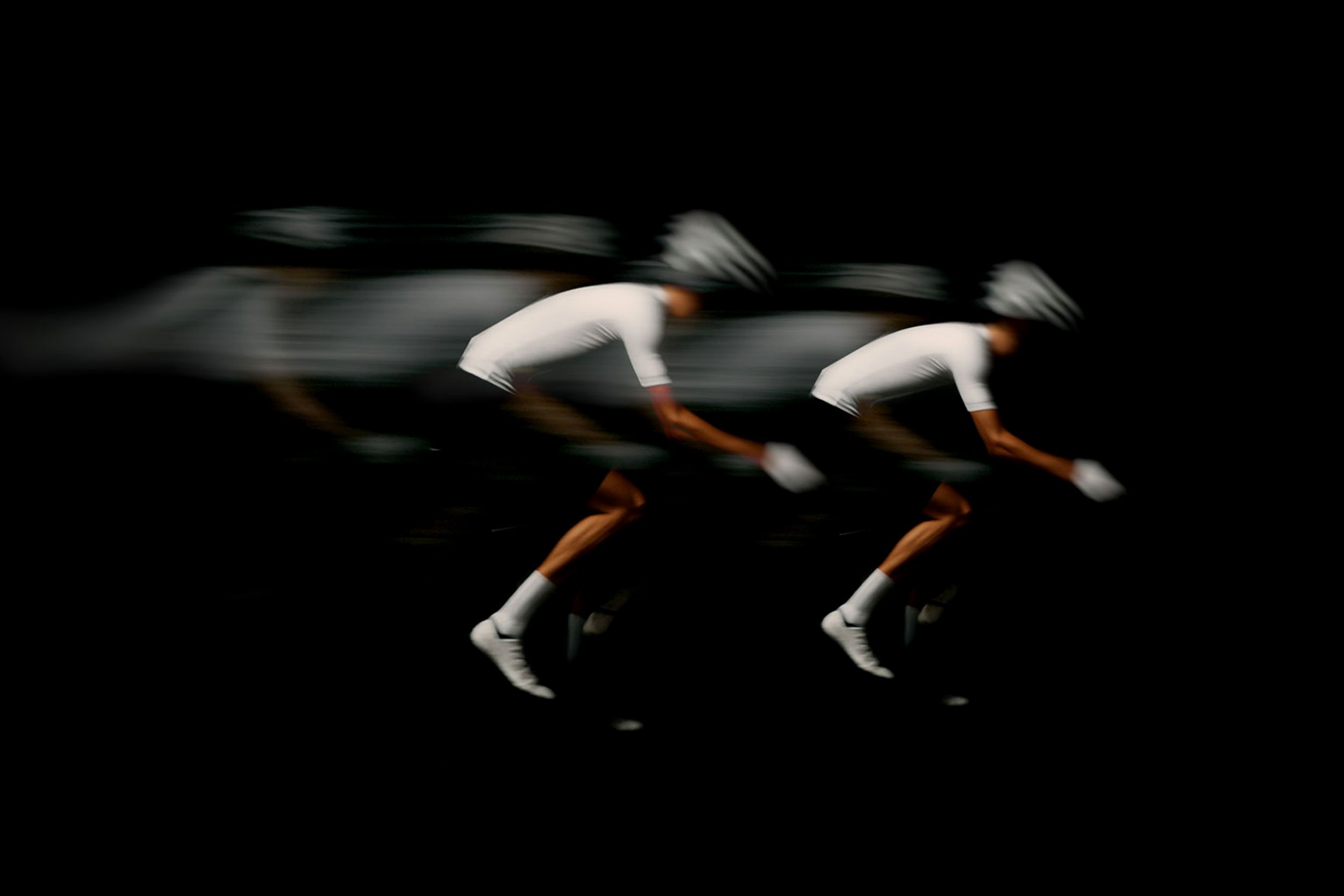 Road cyclists riding at speed, featured in the Alpinum cycling event branding project.