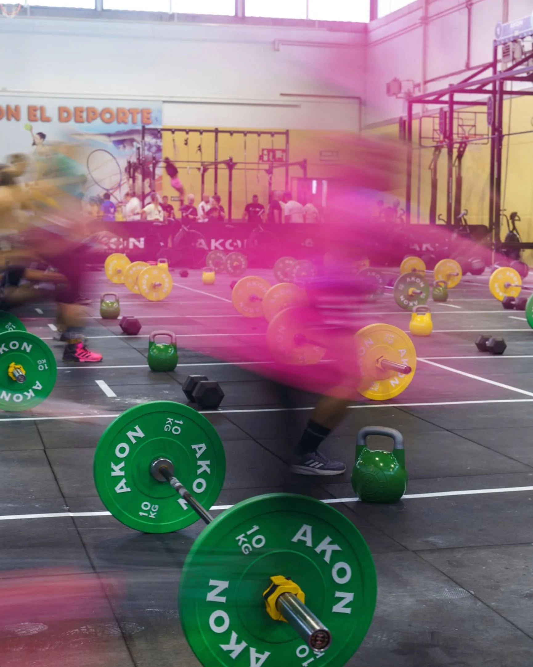 AKON Fitness training equipment in a gym, featuring colourful weight plates and kettlebells.