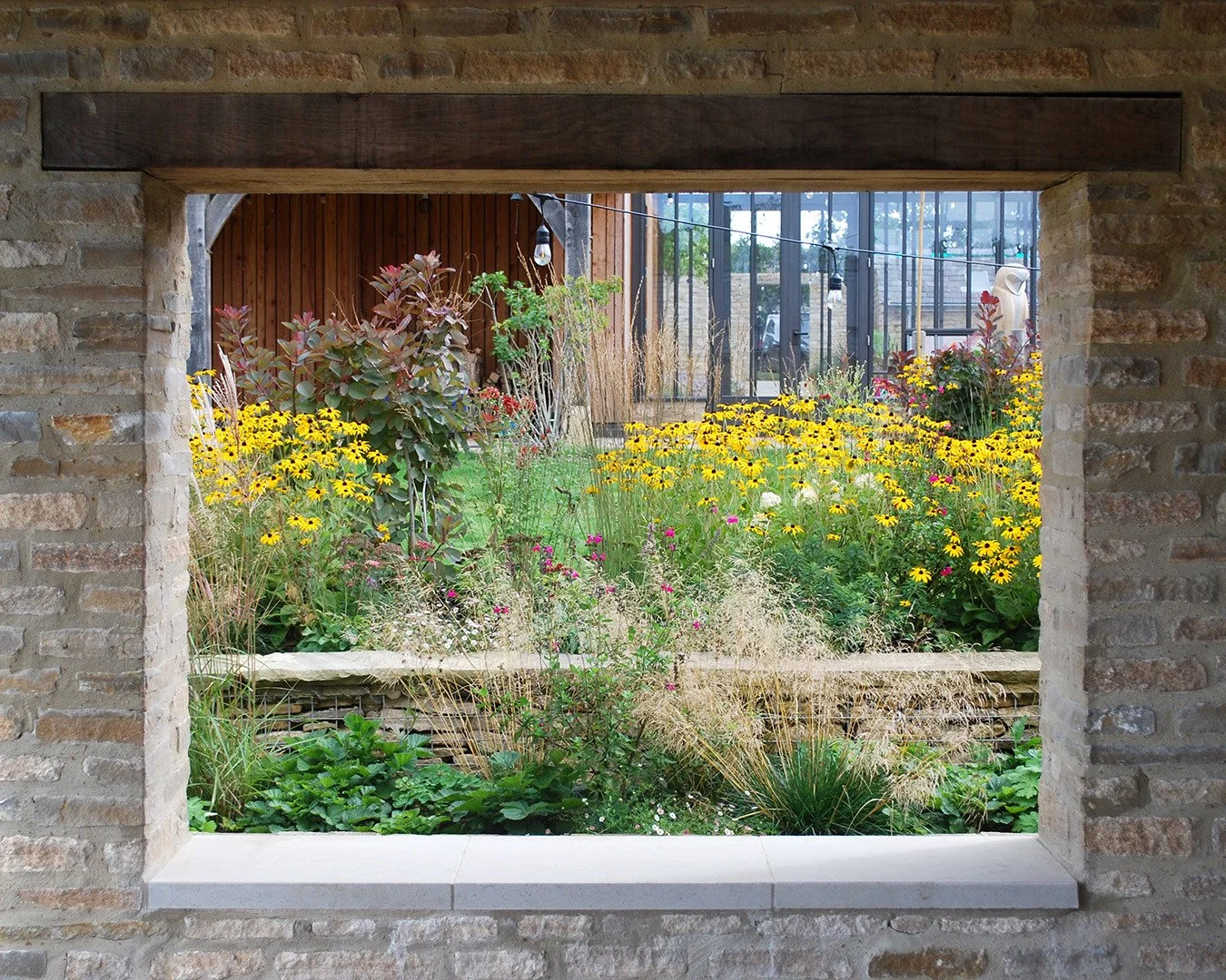 Vignette, glimpses, details...
There are so many places to stop and look in this recently completed garden in Oxfordshire.  Plants are doing amazingly well after being installed earlier this year.
Rudbeckia the usual September showstopper, pair