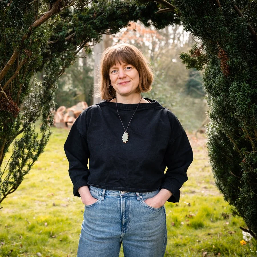 lucy conochie standing under yew hedge