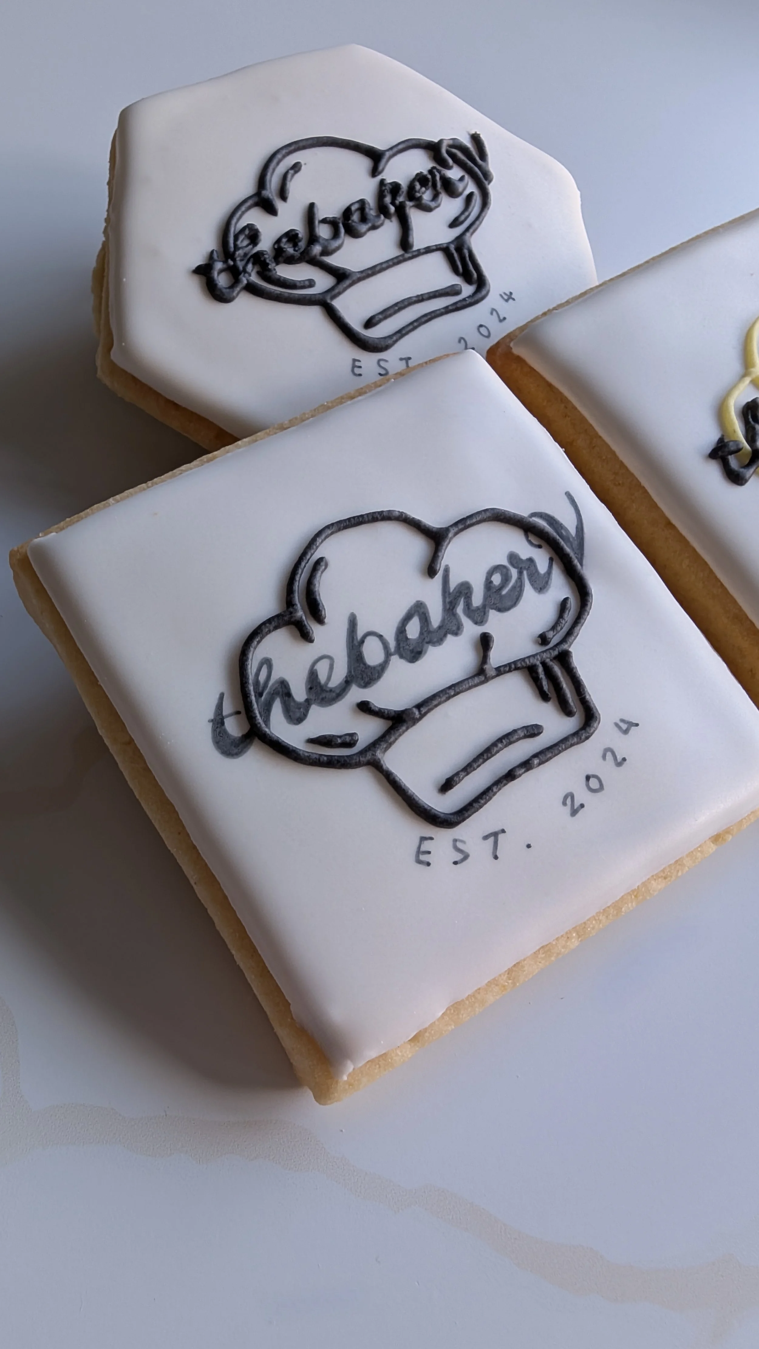 Decorative cookies with celebratory and motivational messages, including a yellow ribbon with the number 1, a red circle with a thumbs-up and the phrase "Well Done!", and a green semi-circle with the words "Celebrate" and a hand making a peace sign.