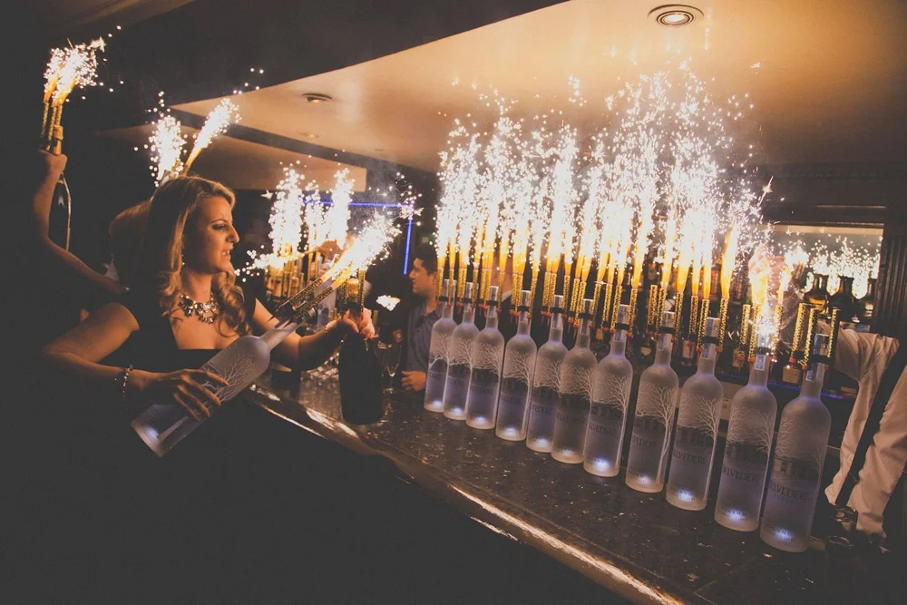 The bar lady gets a round of drinks ready