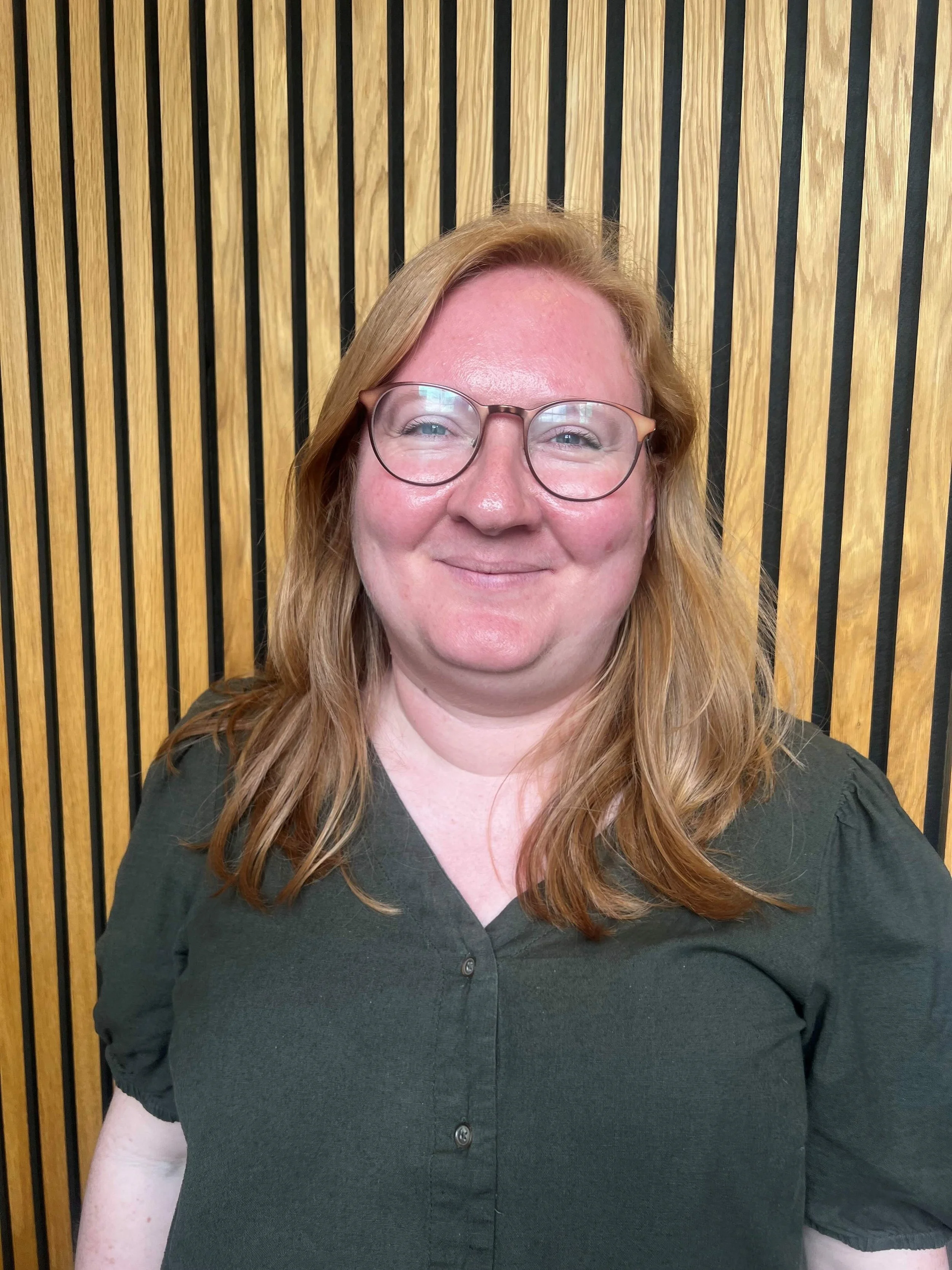 Black and white photo of a stethoscope on a cloth surface.