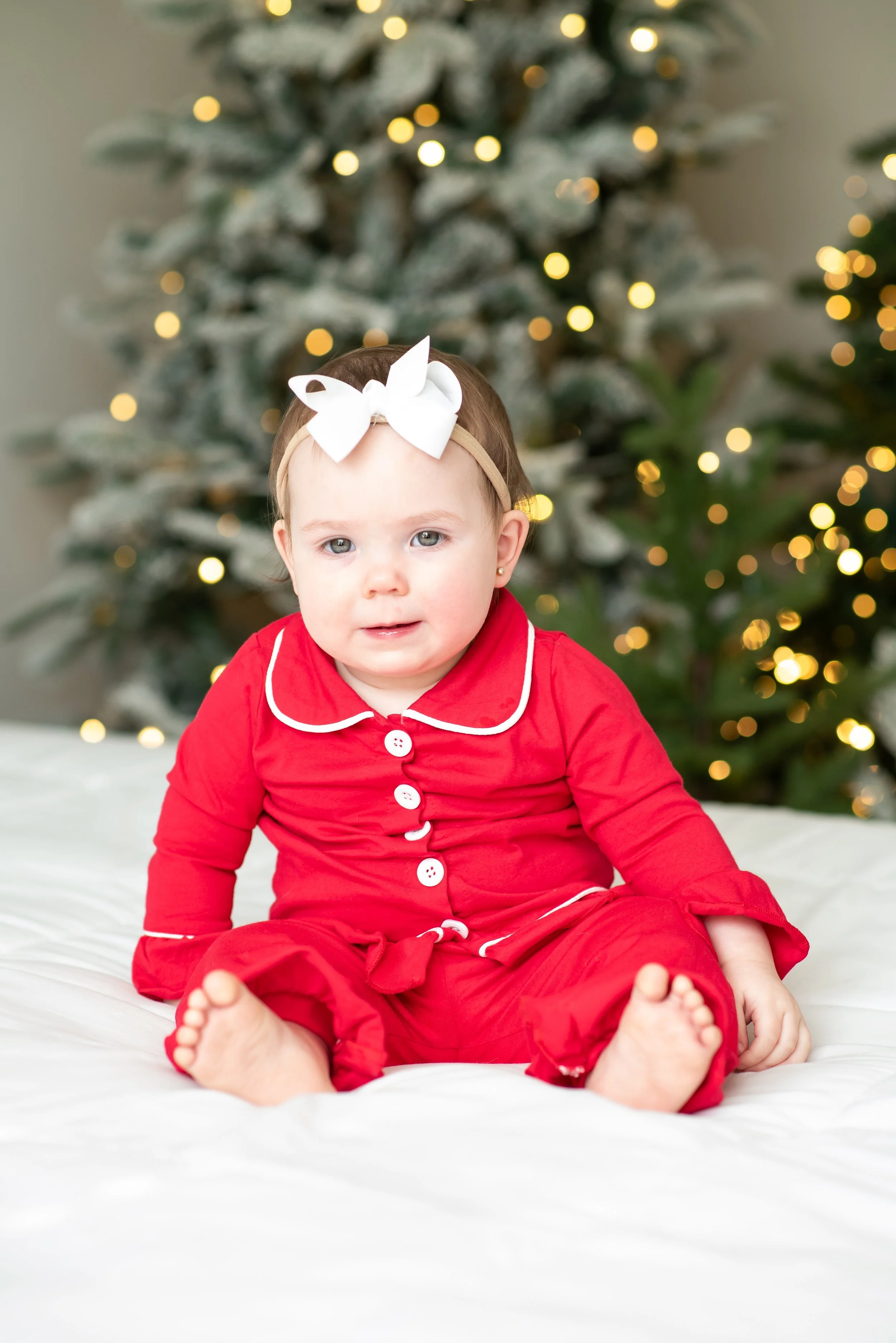 Baby In Jammies in front of tree!