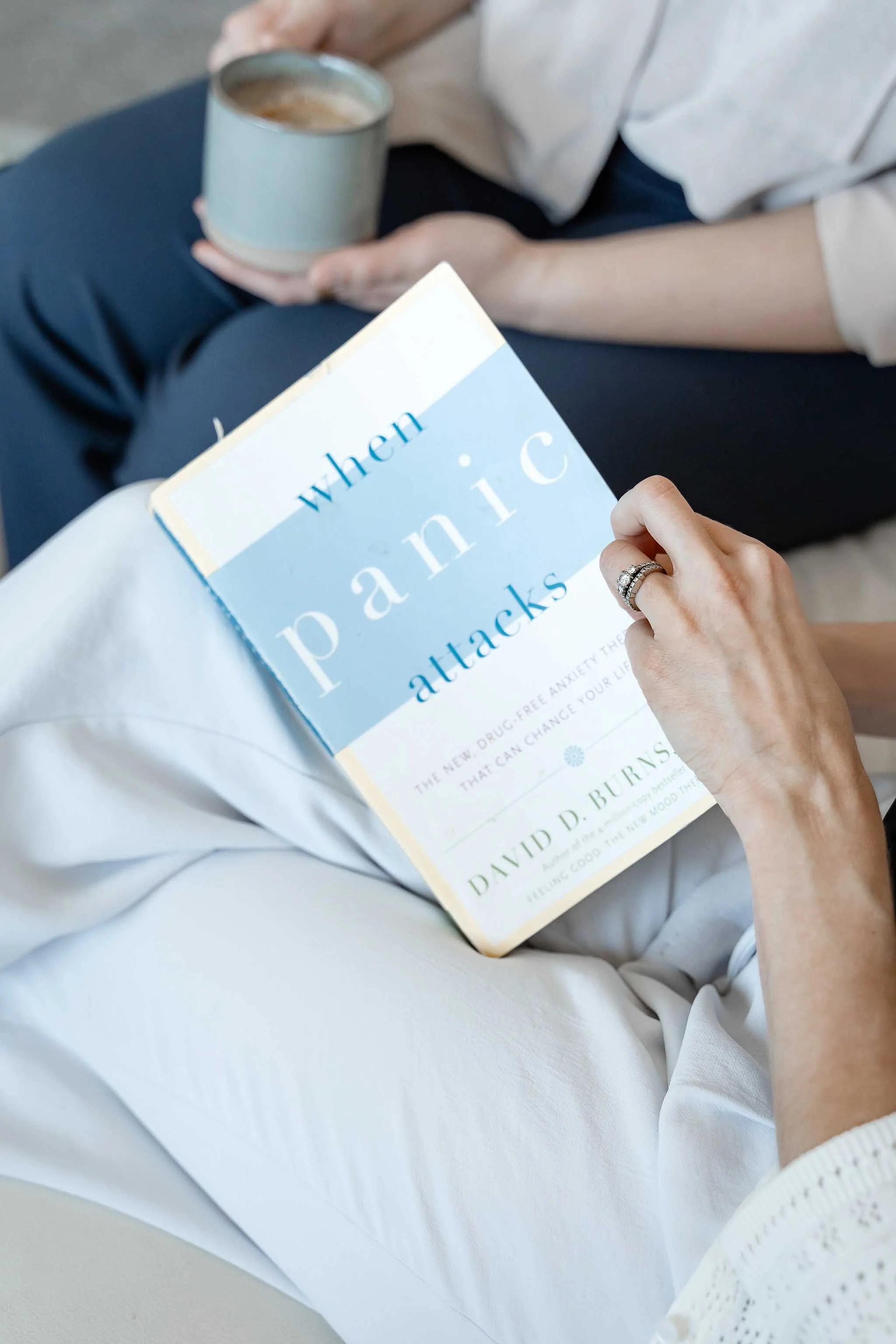 Parent holding an anxiety book during a calm moment, reflecting support for children coping with stressful or traumatic events in Calgary.
