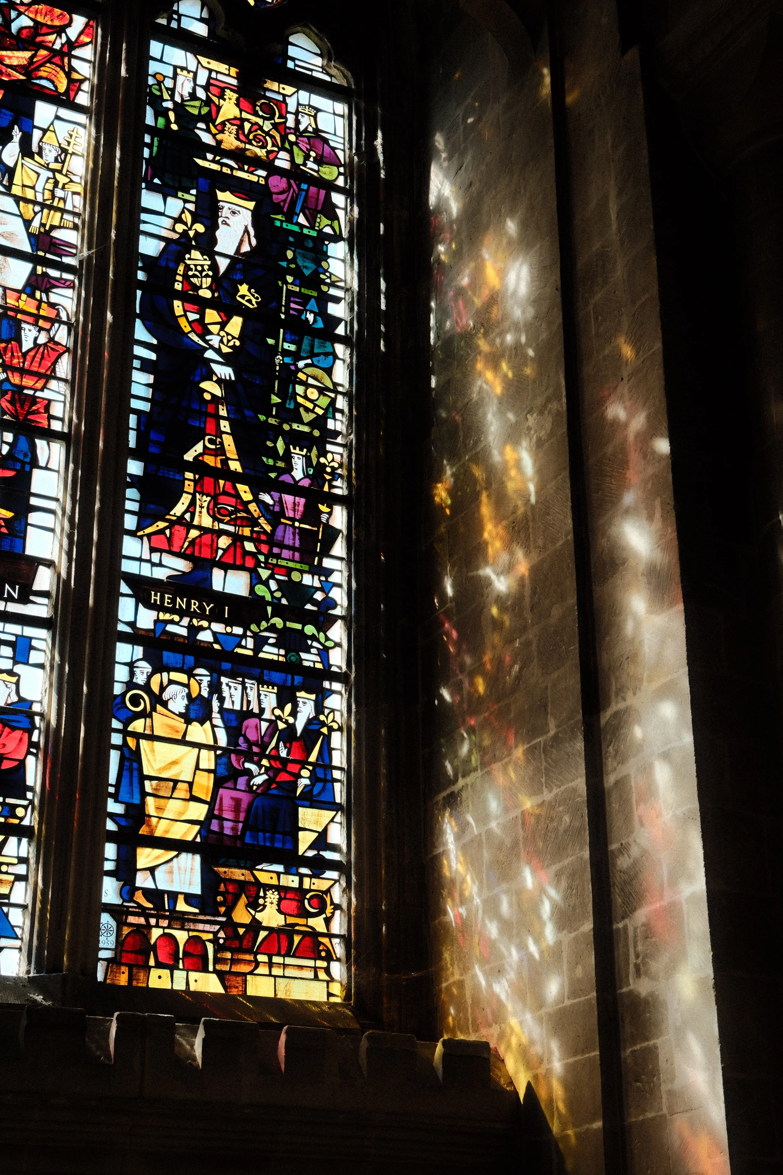 Light shining through the stained glass window of Canterbury Cathedral