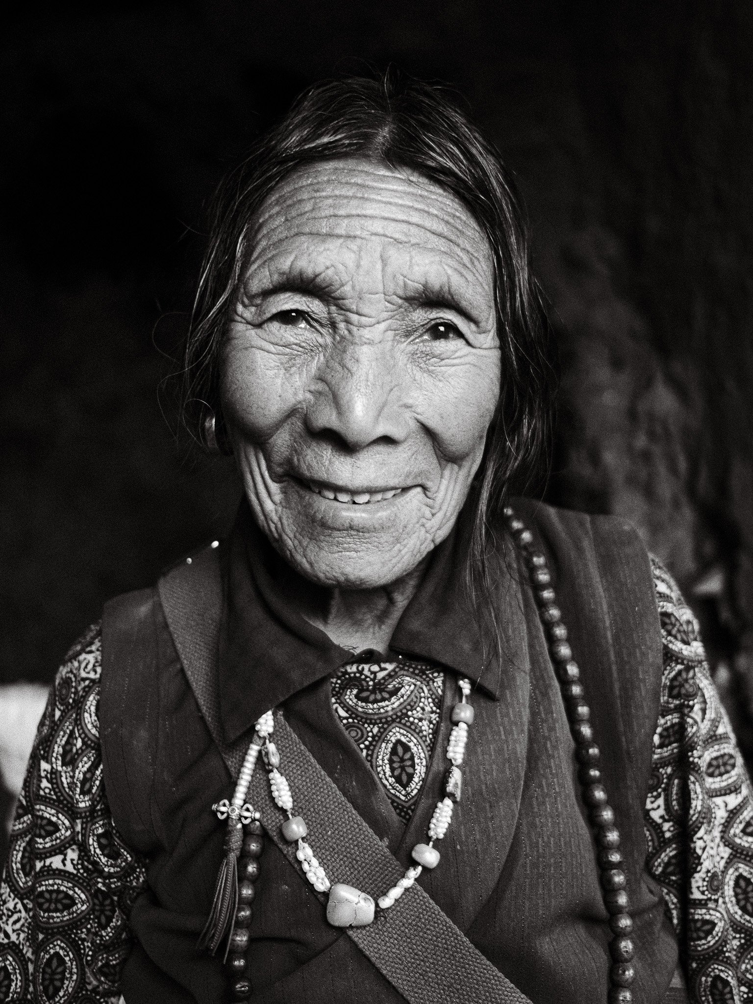 a black and white portrait photo of an elderly Nepali woman in Upper Mustang, Nepal