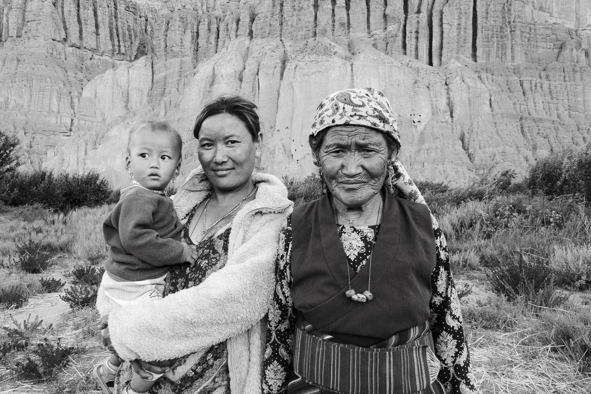 black and white photo of three generations of females from one family in chuksang, upper mustang