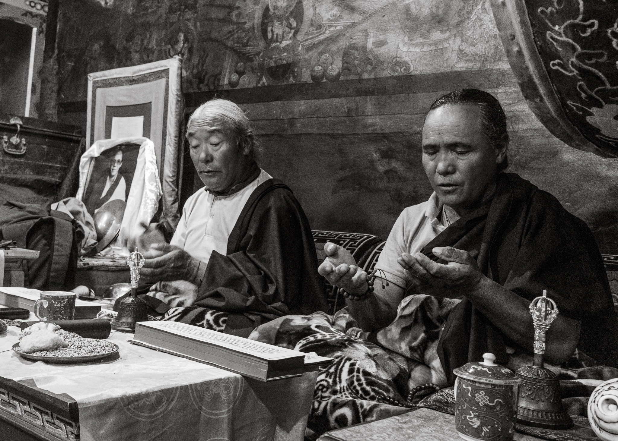 Black and white photo of monks performing a puja ceremony at Luri Gompa in Upper Mustang