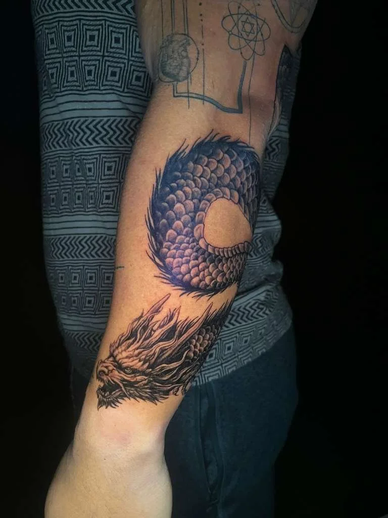 black and grey realistic dragon tattoo