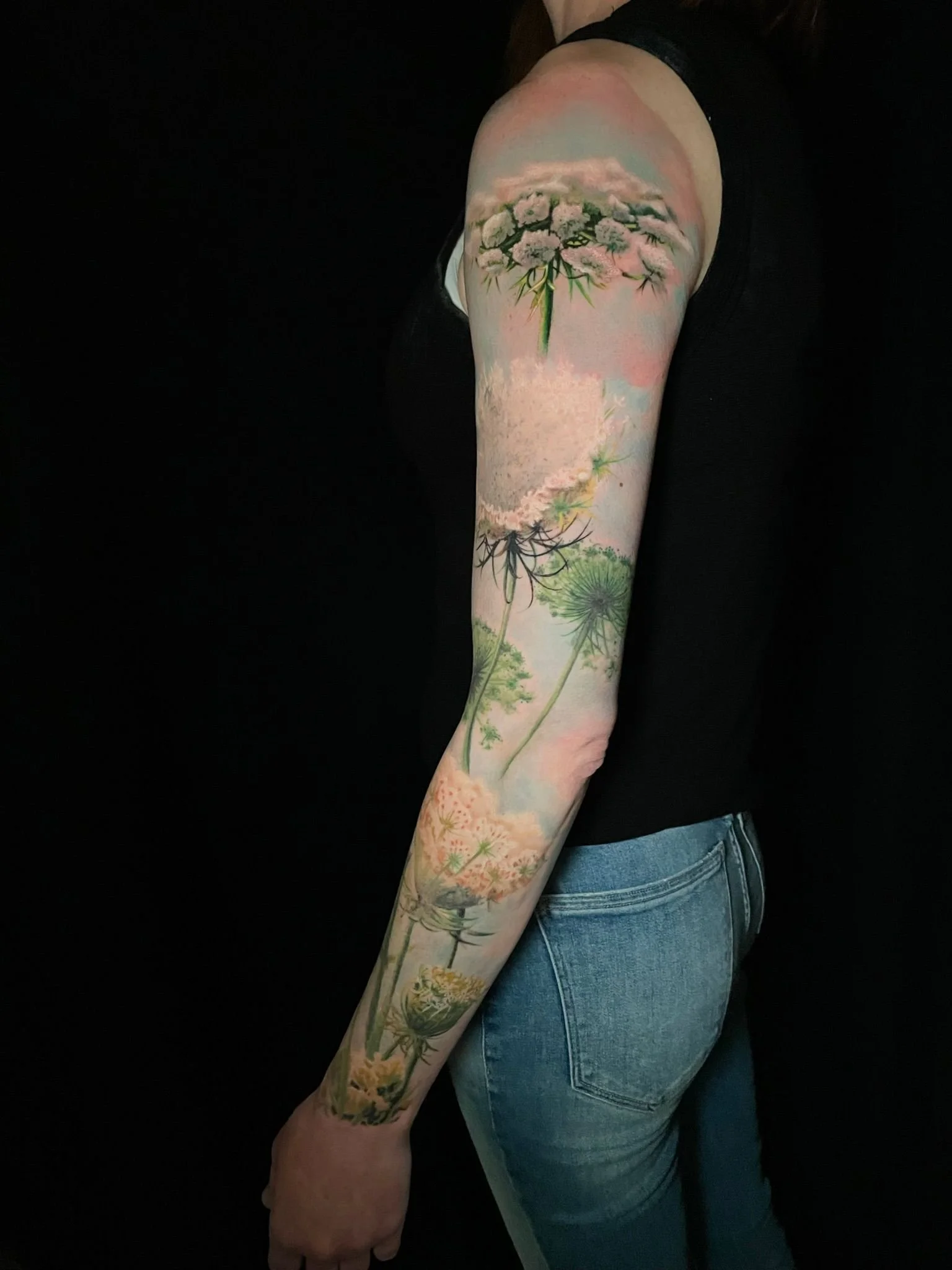 delicate color nature flowers floral arm sleeve tattoo