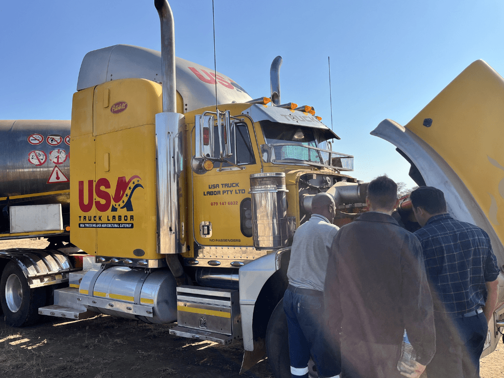 image of truck maintenance training on large yellow Peterbilt truck