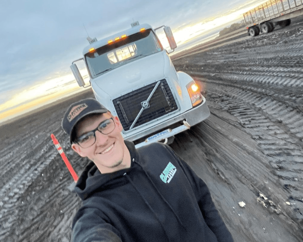 image of worker in a H2A job by a truck