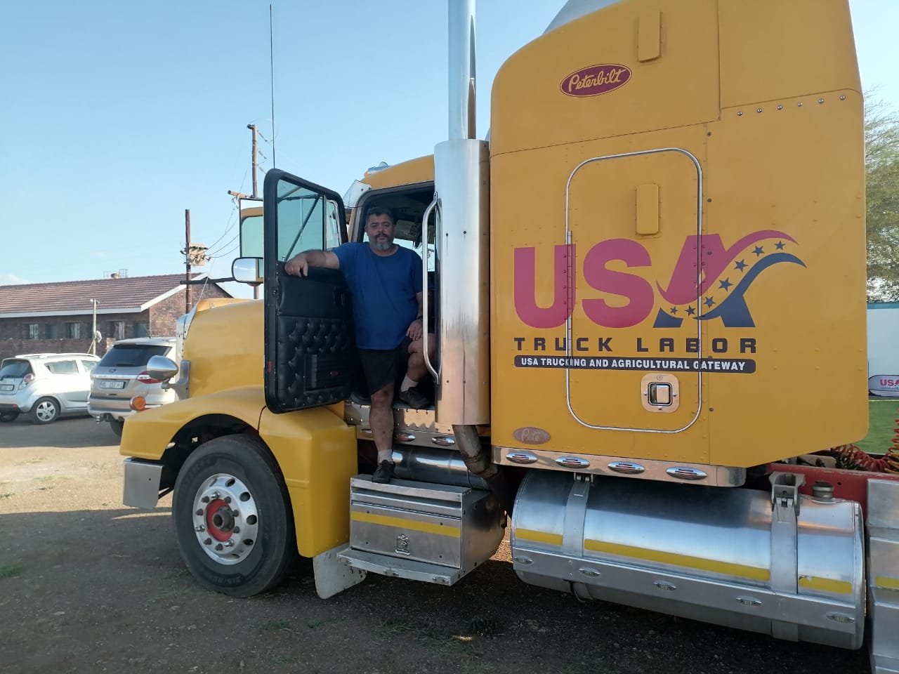 guy in big yellow truck after verifying his farmworker skills
