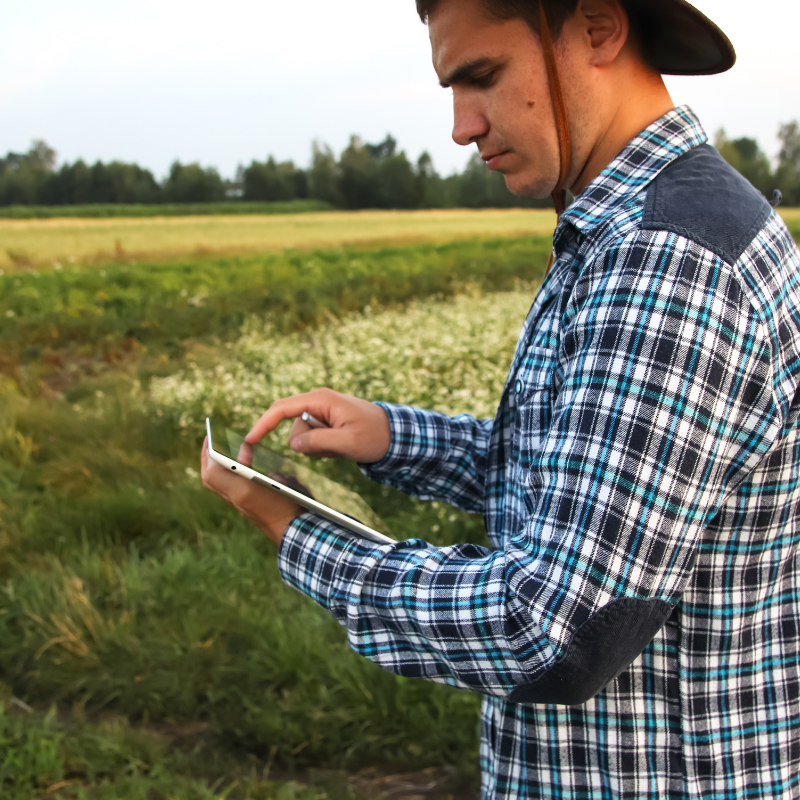 image of farmworker using GPS tech for farming in America
