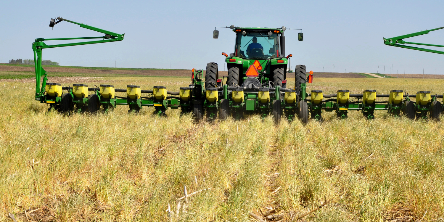 image of tractor with sprayer attached using H-2A in America