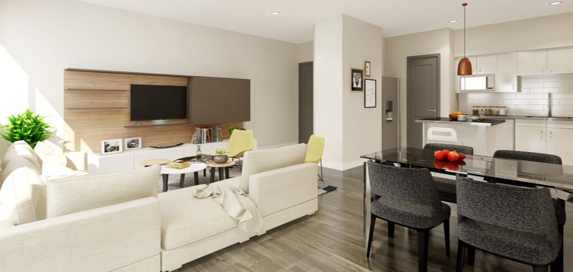 Interior view of a unit showing the living room, dining area, and kitchen with modern finishes.