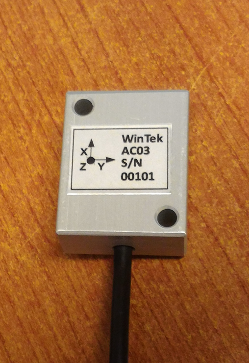 WinTek AC03 sensor device on wooden surface