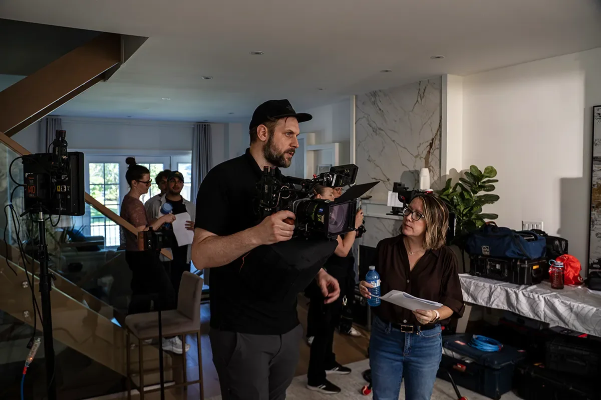 Iceberg Media Productions' Founder Laura Hepes on set for Appleton Estate's broadcast commercial shoot discussing framing for the next shot with cinematographer James Featherstone.