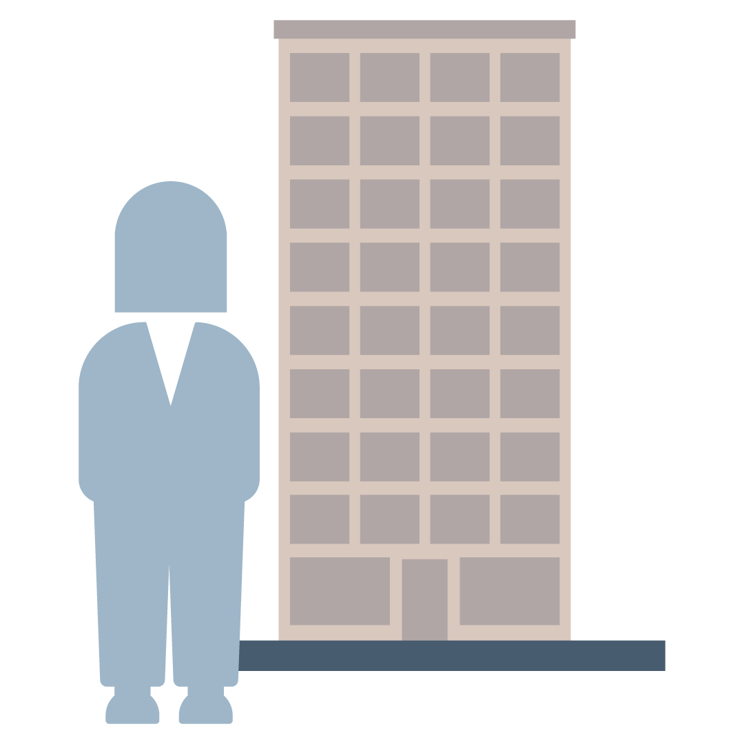 A commercial agent standing next to a building.
