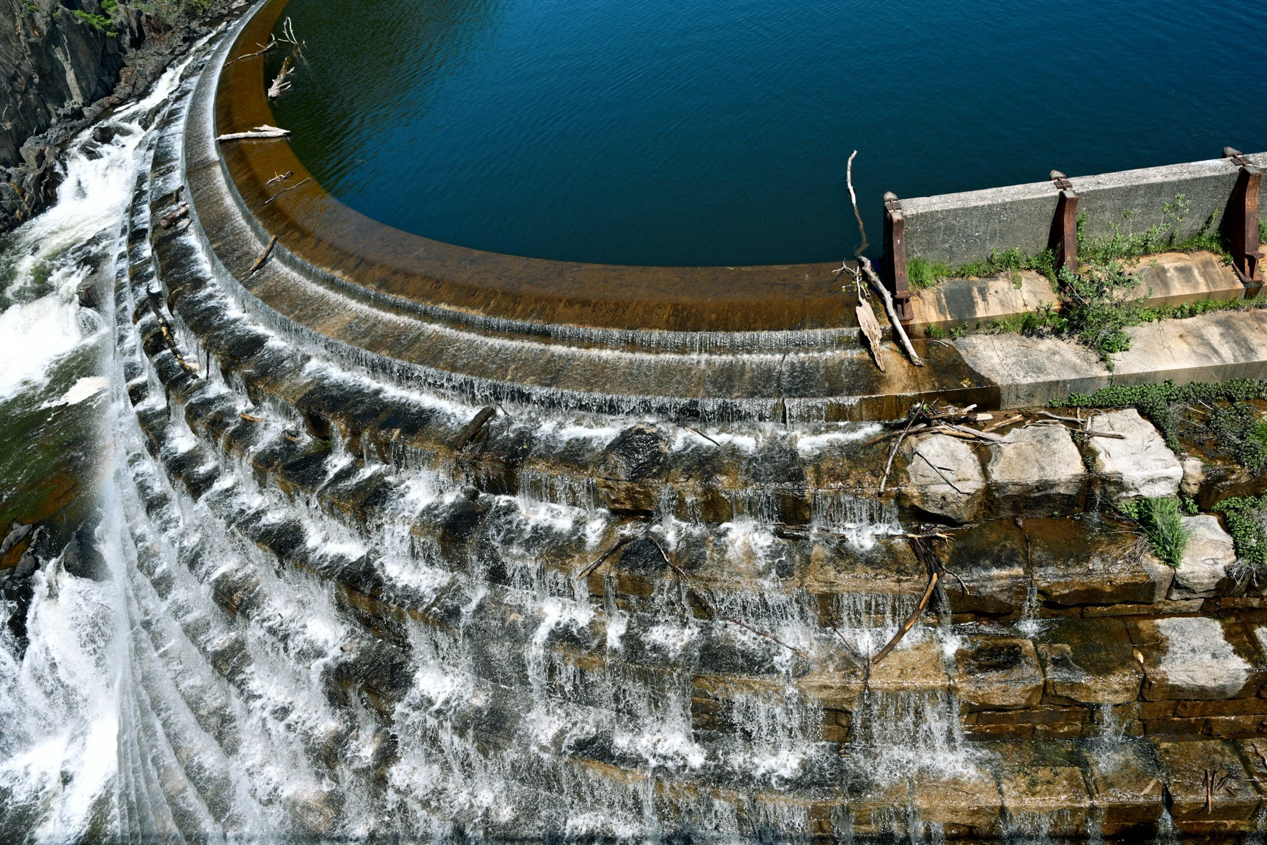 Image showing a stepped spillway discharging excess water and carrying branches downstream