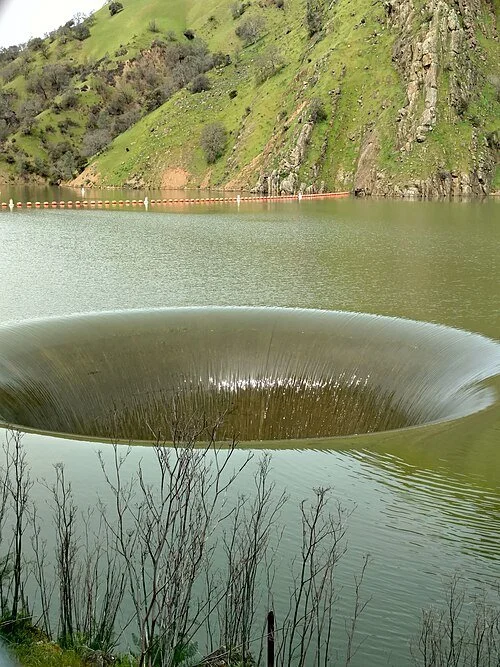Rare gloryhole spillway created by overflow of Lake Berryessa at Monticello Dam, California, March 2017.