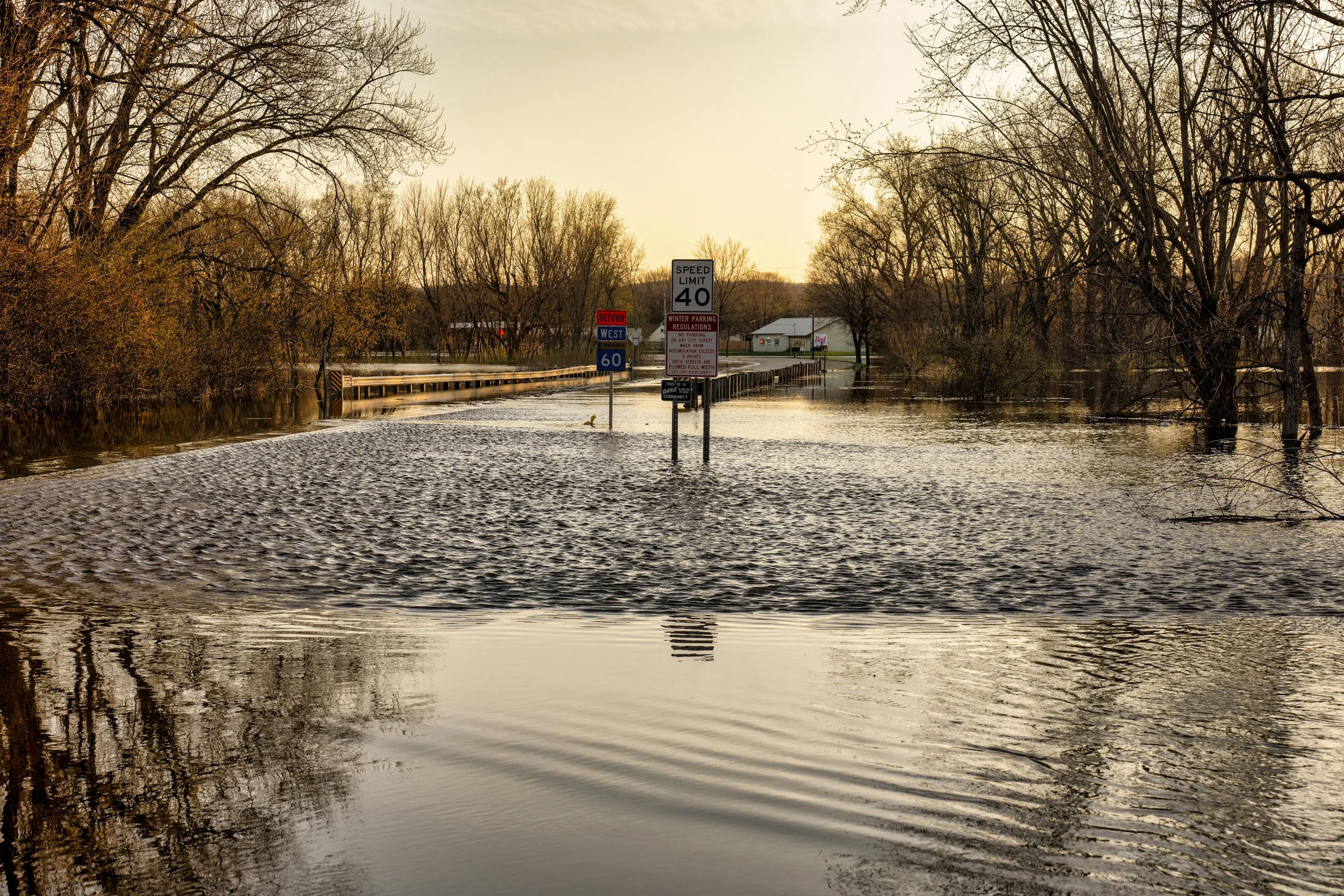 Photograph showing a bridge that has been inundated with flood waters, making Interstate 60 impassable