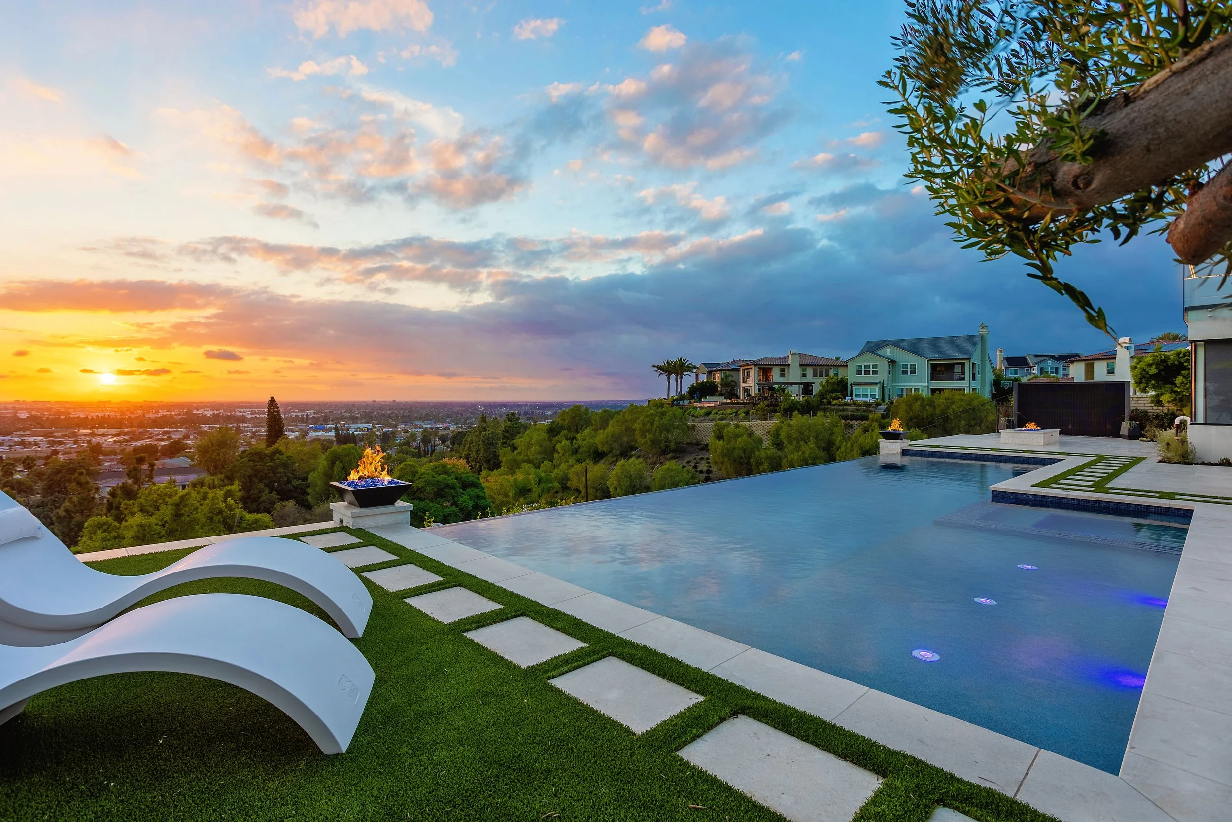 Infinity pool with fire features and scenic sunset views, designed by VW Design and Build in Orange, California.
