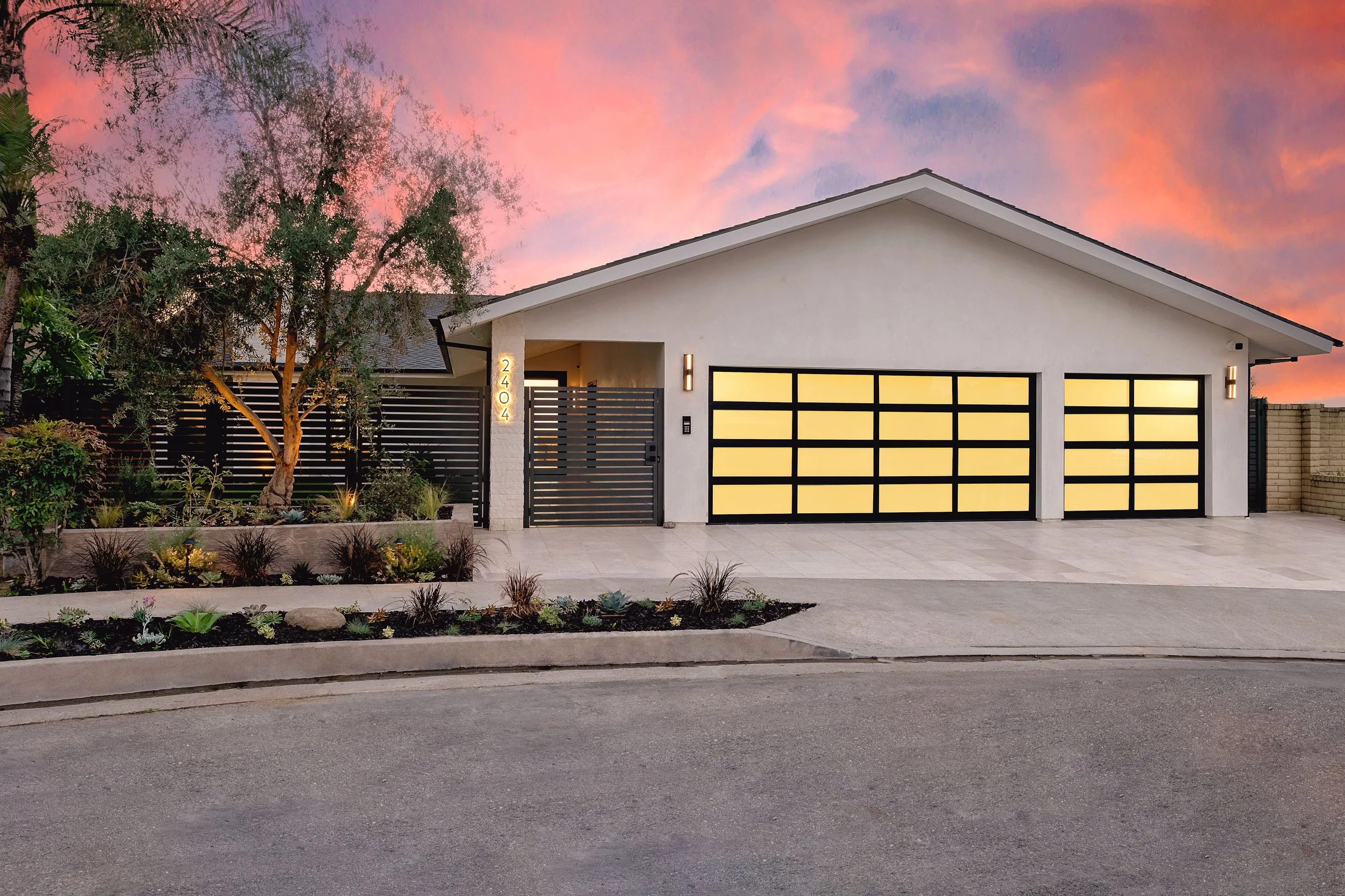 Modern home exterior with sleek garage doors and contemporary landscaping in Orange, California.