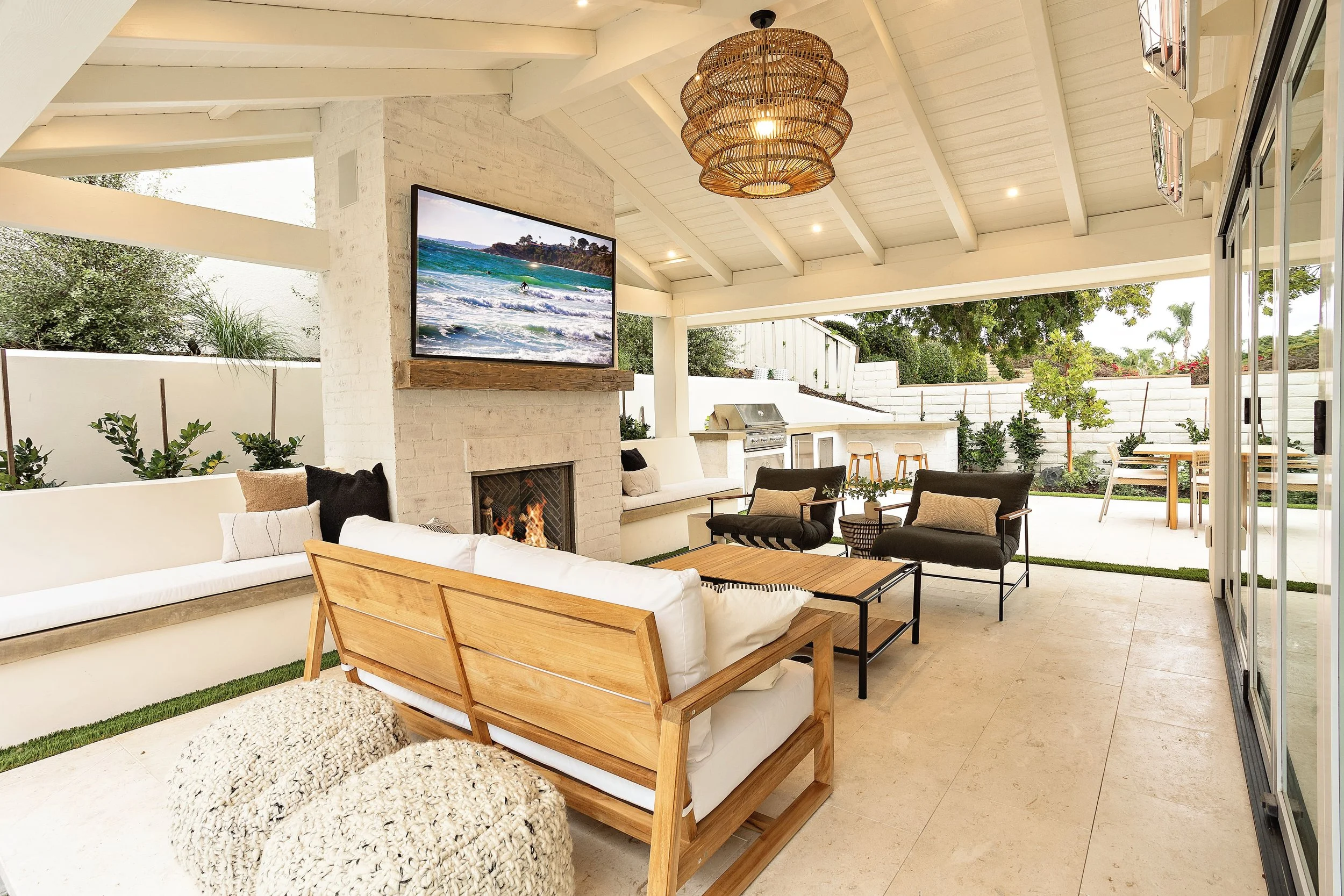 Cozy outdoor living room with fireplace and modern furniture in Newport Beach, designed by VW Design and Build.