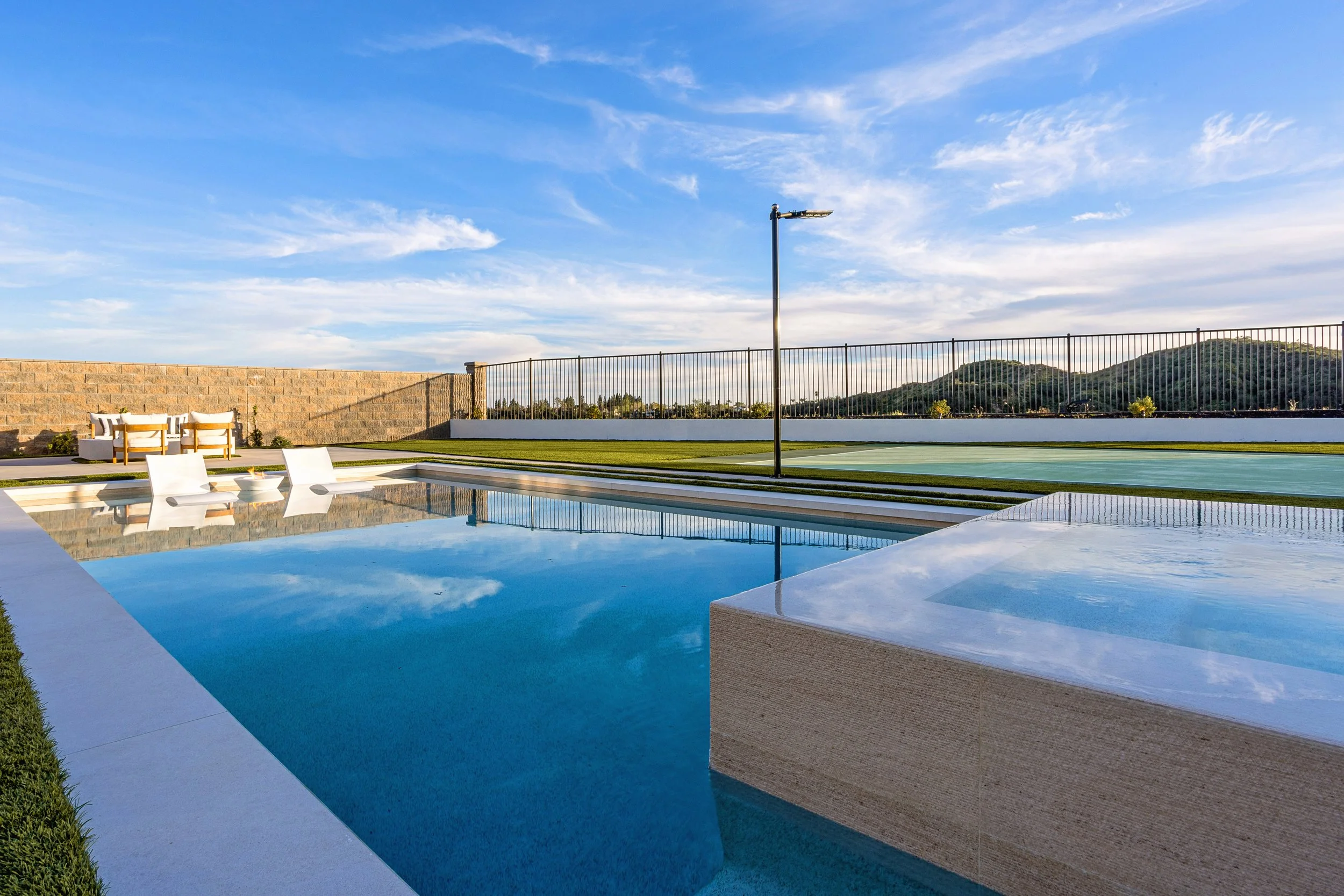 A ground-up custom home build in Silverado Canyon featuring a modern pool and spa, manicured outdoor living areas, and panoramic canyon views designed for effortless indoor-outdoor living.
