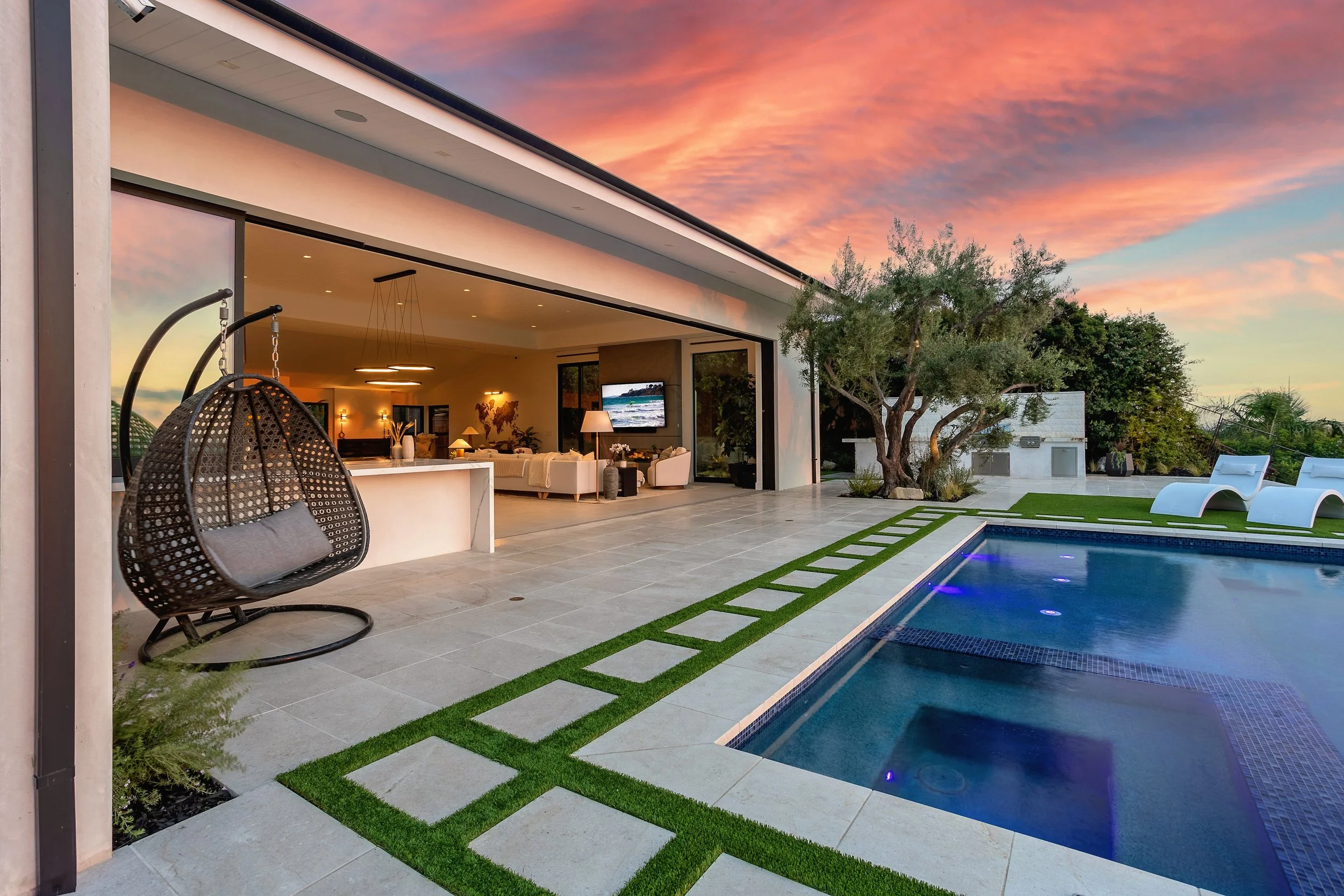Contemporary indoor-outdoor space with a pool and open living area, created by VW Design and Build in Orange, CA.