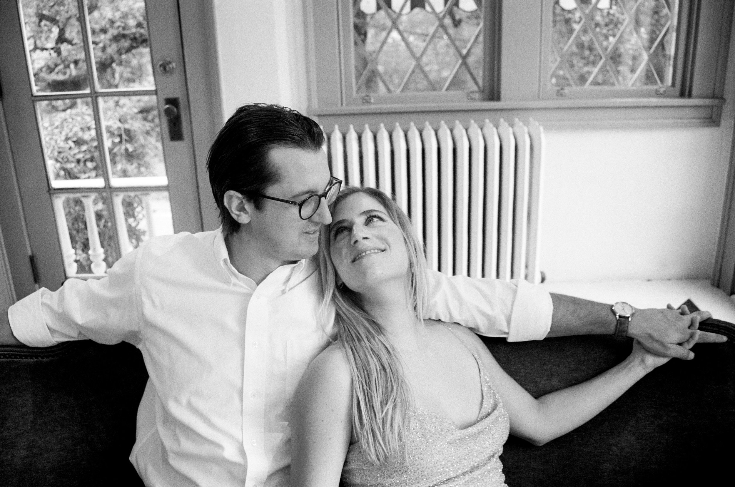 Couple looks into each others' eyes sitting on a bench