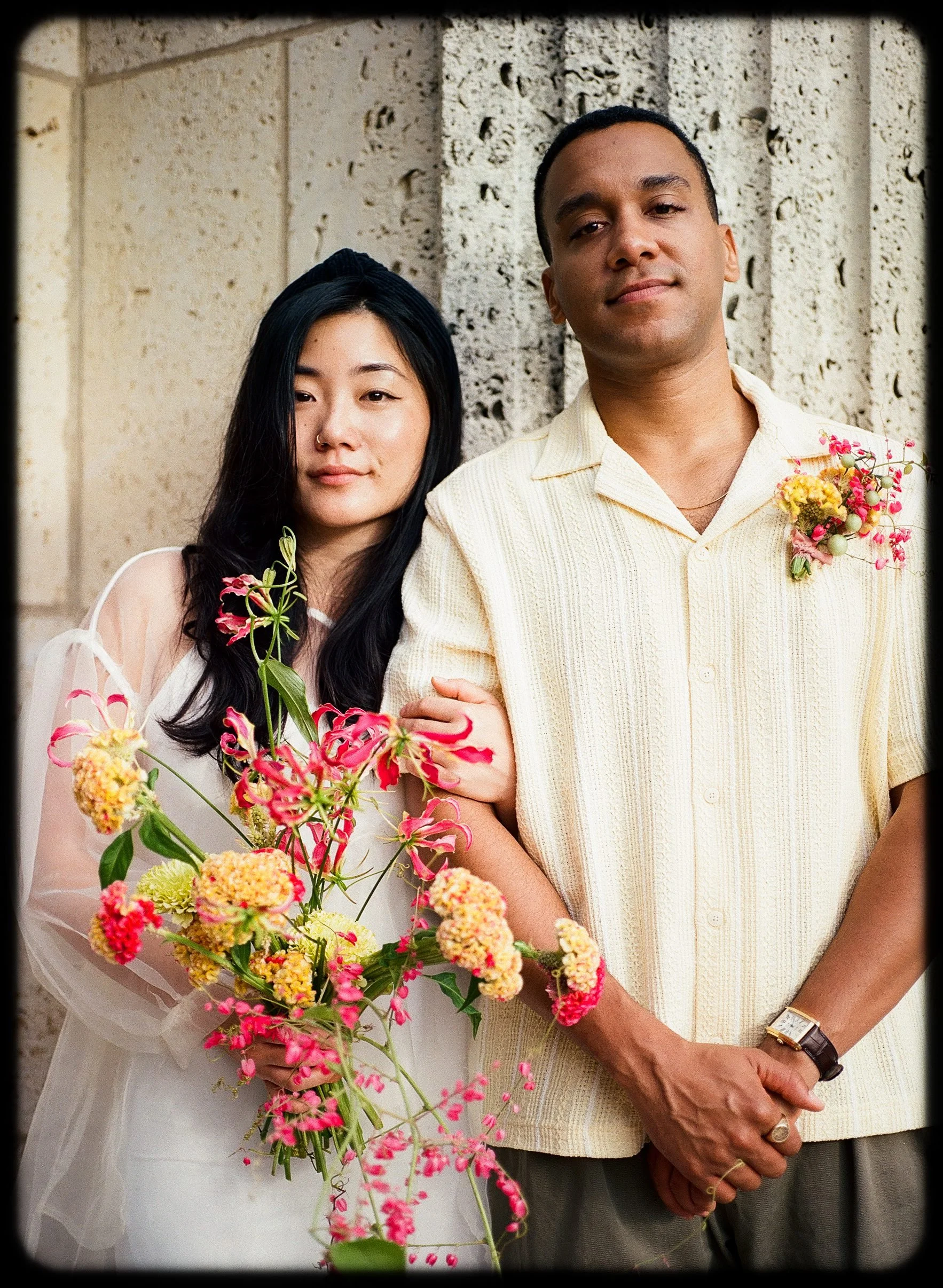 Couple eloping with bouquet