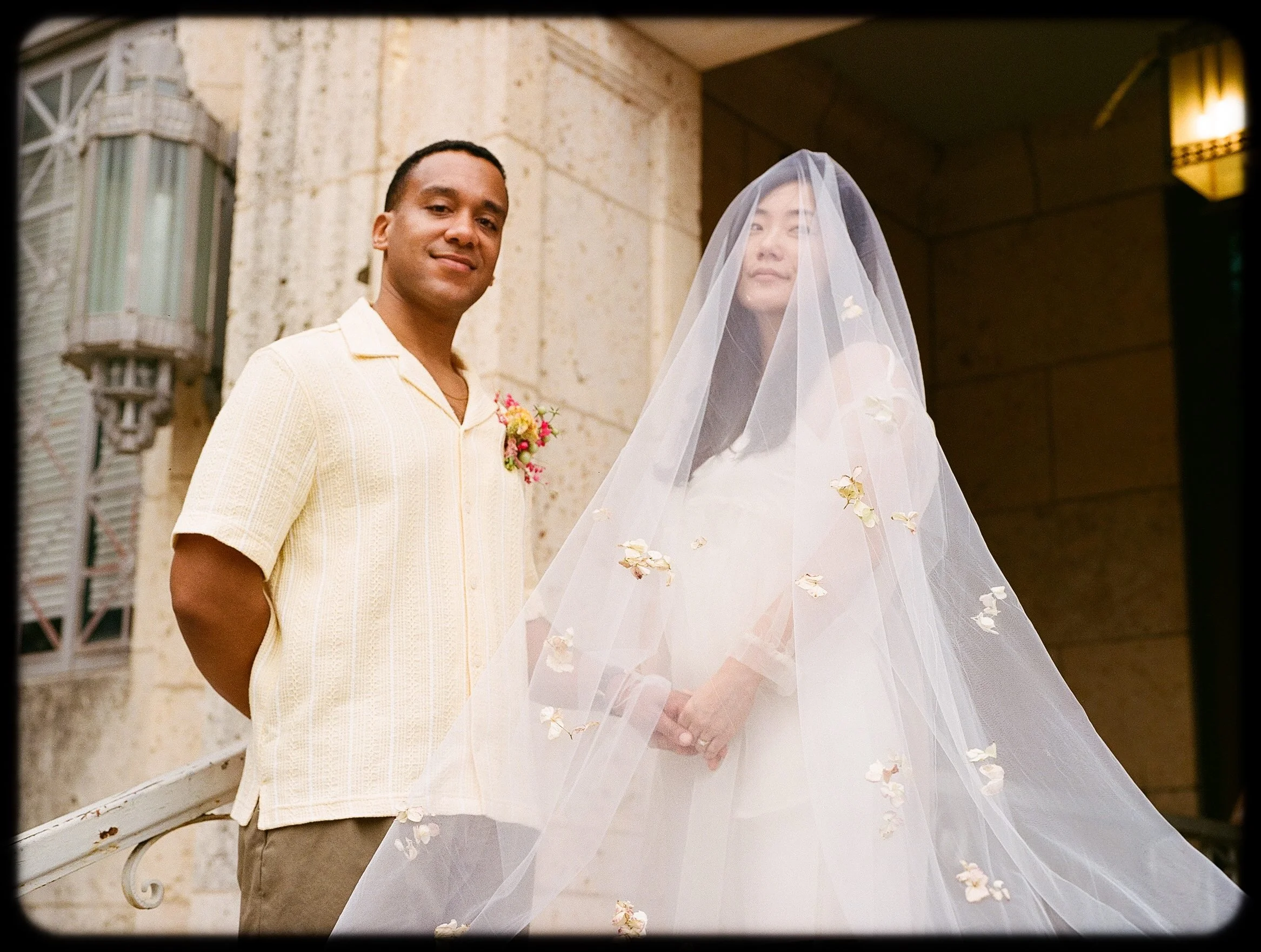 Couple with veil at ATX Courthouse Elopement