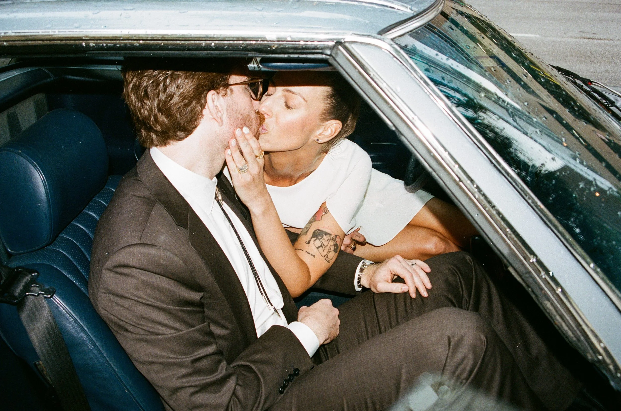 Couple kissing in vintage car