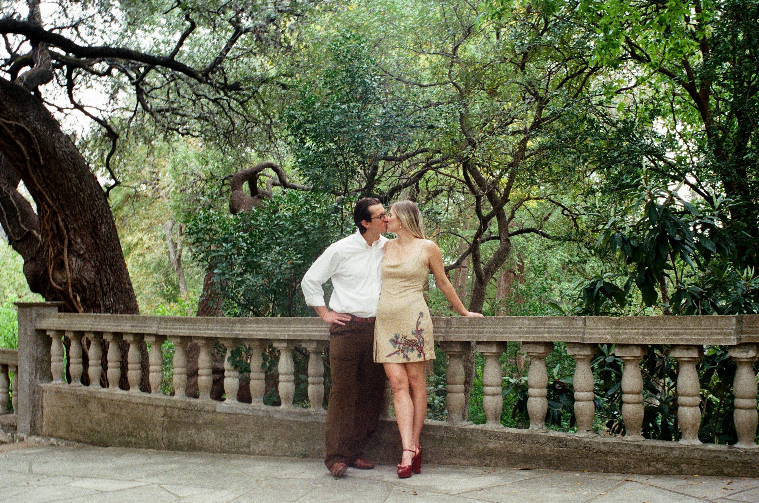 Couple kissing on stone bridge
