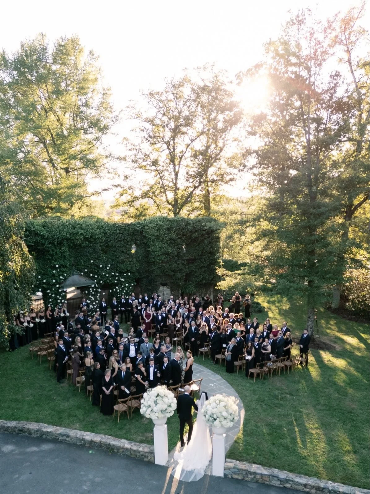 This ceremony was guided by the setting from the very beginning.

Surrounded by layered greenery and late afternoon light, we approached the design with intention, introducing white florals that echoed the softness of the space without competing with