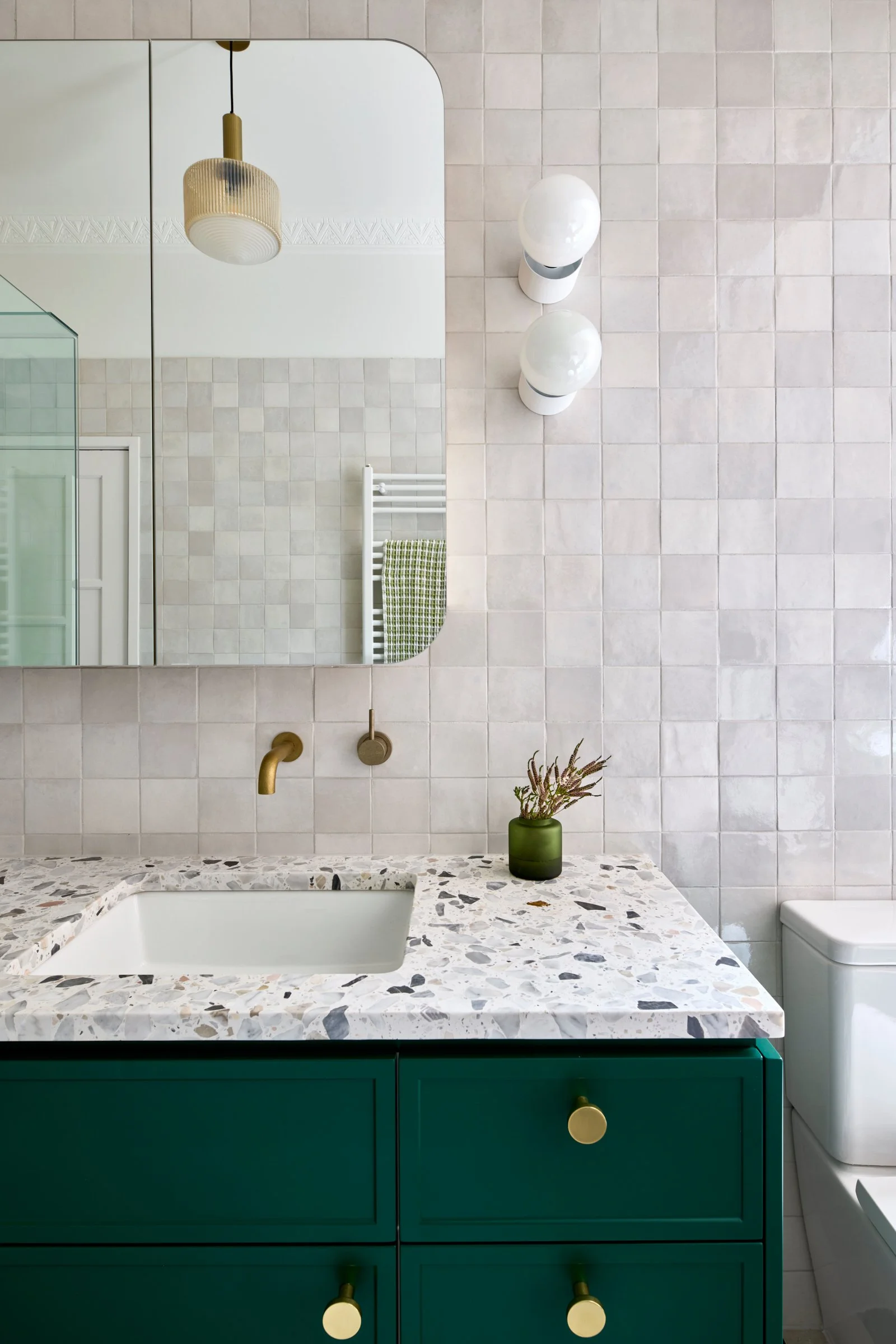 Green bathroom cabinet in an Art Deco house by Sheri Haby Architects, Caulfield North