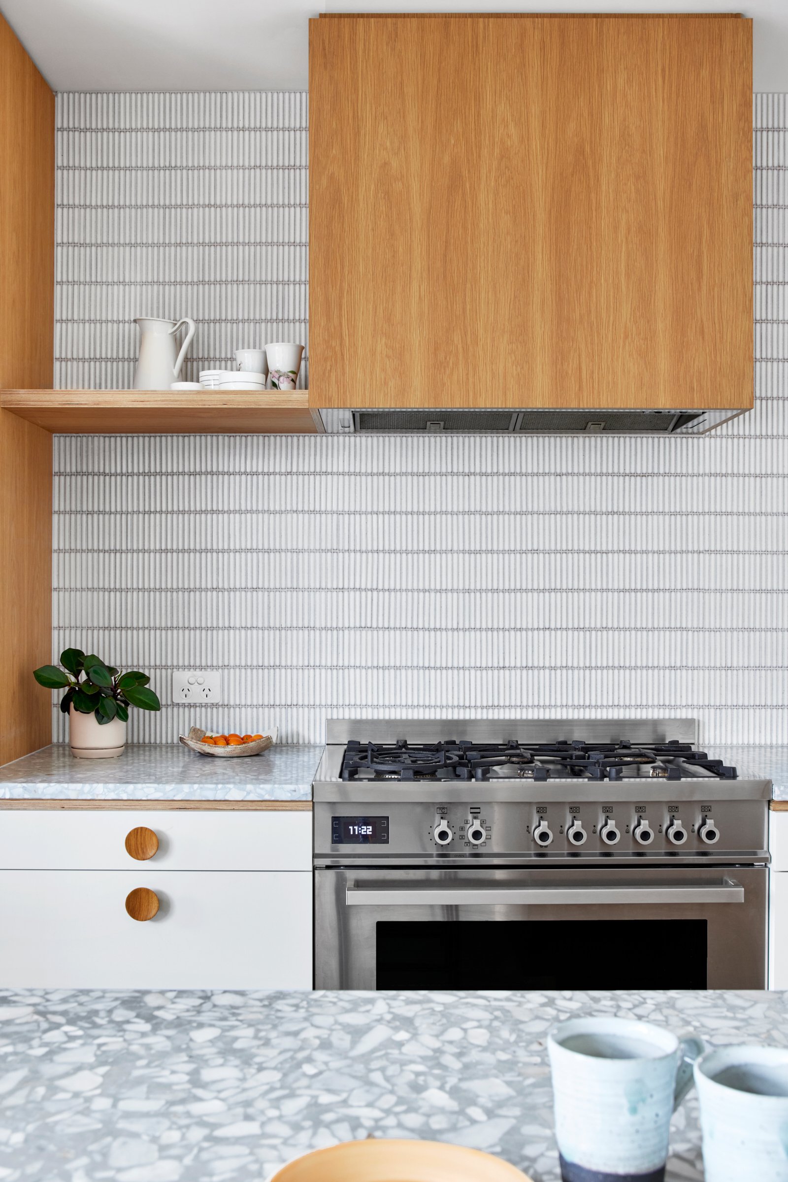 Warm oak, soft whites and tactile terrazzo create a relaxed, light-filled Bayside feel.