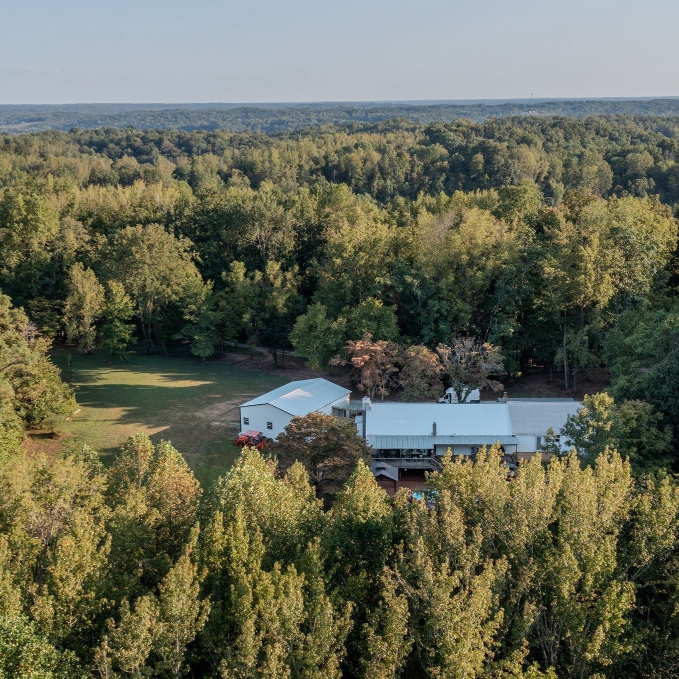 FOR SALE 🍁 FALL IN LOVE WITH FALL ALL OVER AGAIN!
Discover a rare ranch-style retreat on 24 acres, featuring expansive porches, a cozy stone fireplace, and a hot tub view perfect for fall evenings.
Enjoy open-concept living, a spa-like primary suite