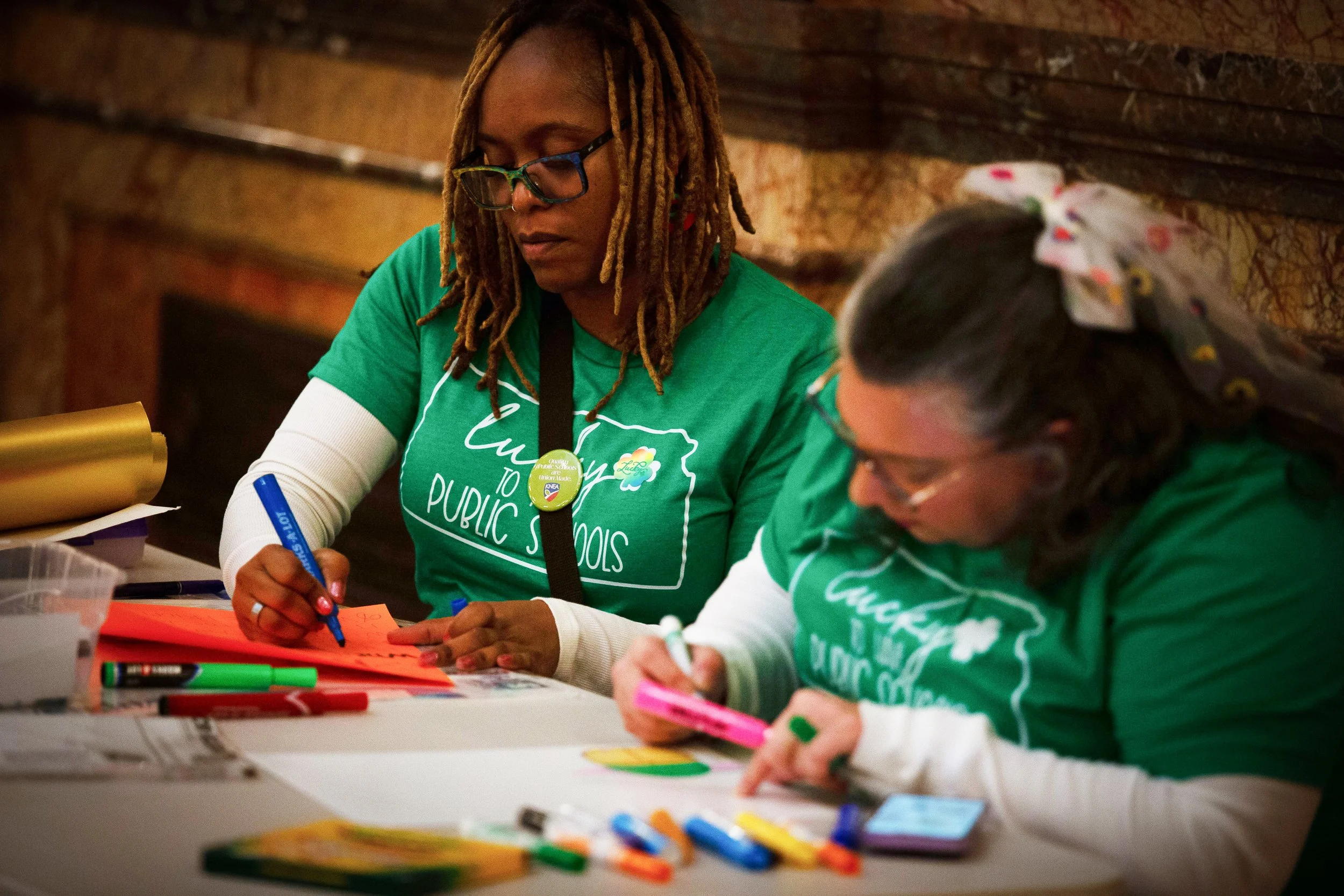   PHOTO COURTESY OF ANTHONY BUSH    Attendees were able to make posters in preparation for the Lucky to Have Kanas Public Schools Rally on Tuesday, March 17, at the Statehouse in Topeka.  