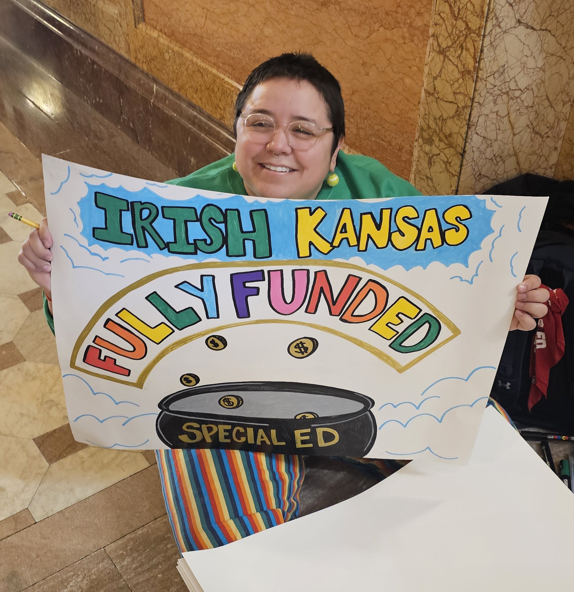   PHOTO BY ANN MARIE BUSH/KNEA    Emerson Hoffzales, Lawrence Education Association, created several posters for the rally on Tuesday, March 17.  