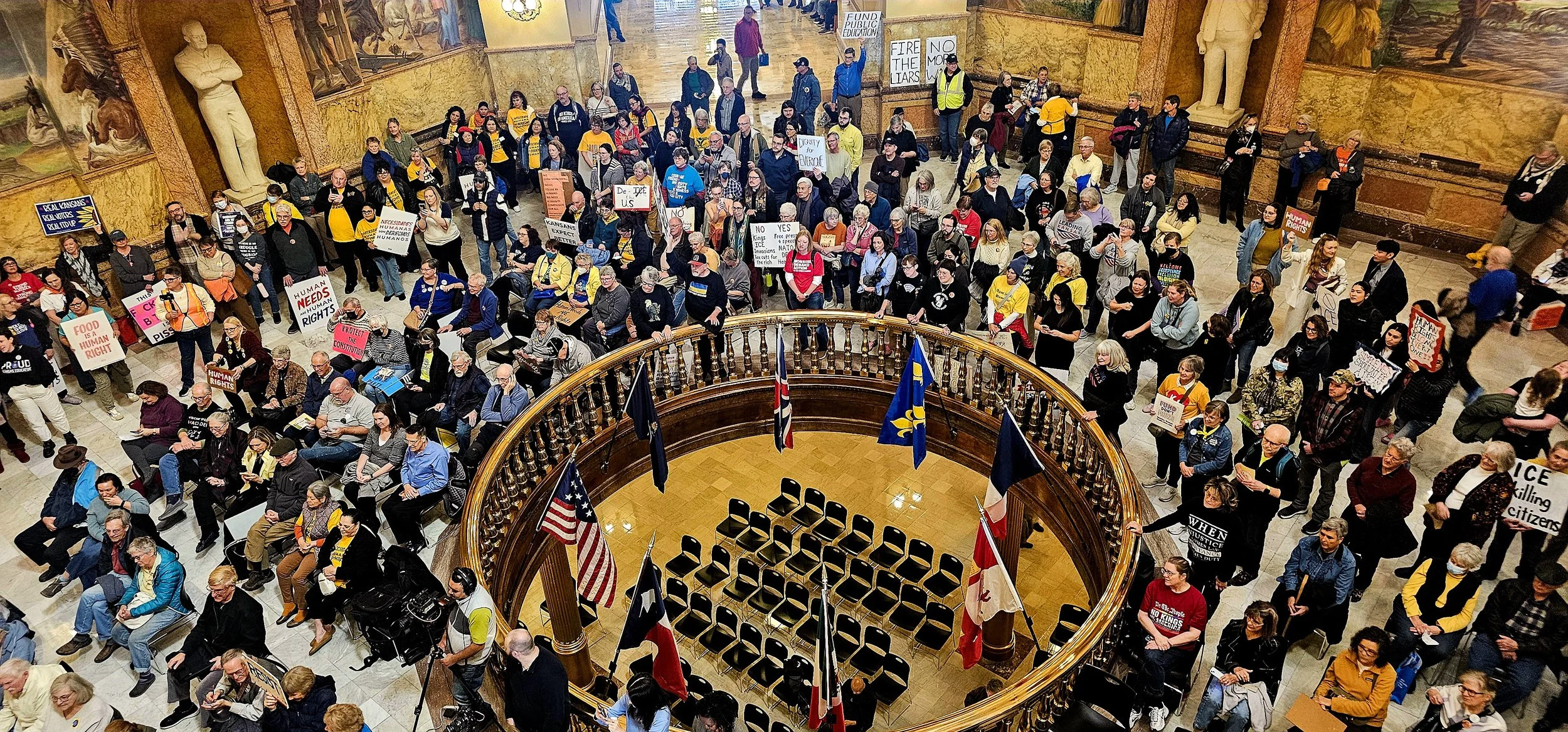 A group of people gathered at the Statehouse in Topeka for a rally.