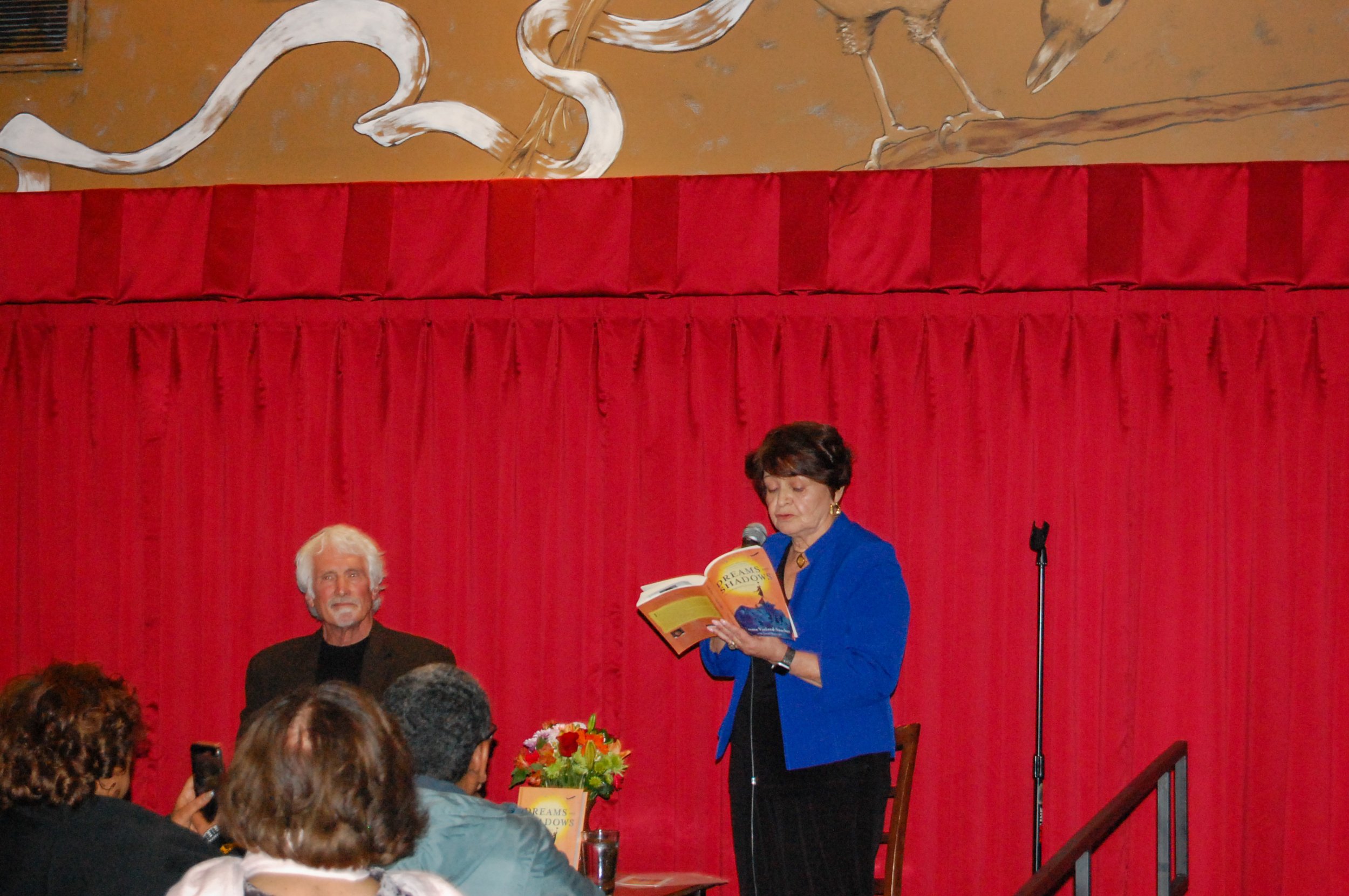 Emma reads a passage from Dreams and Shadows: An Immigrant’s Journey during book launch at Busboys and Poets - Busboys and Poets