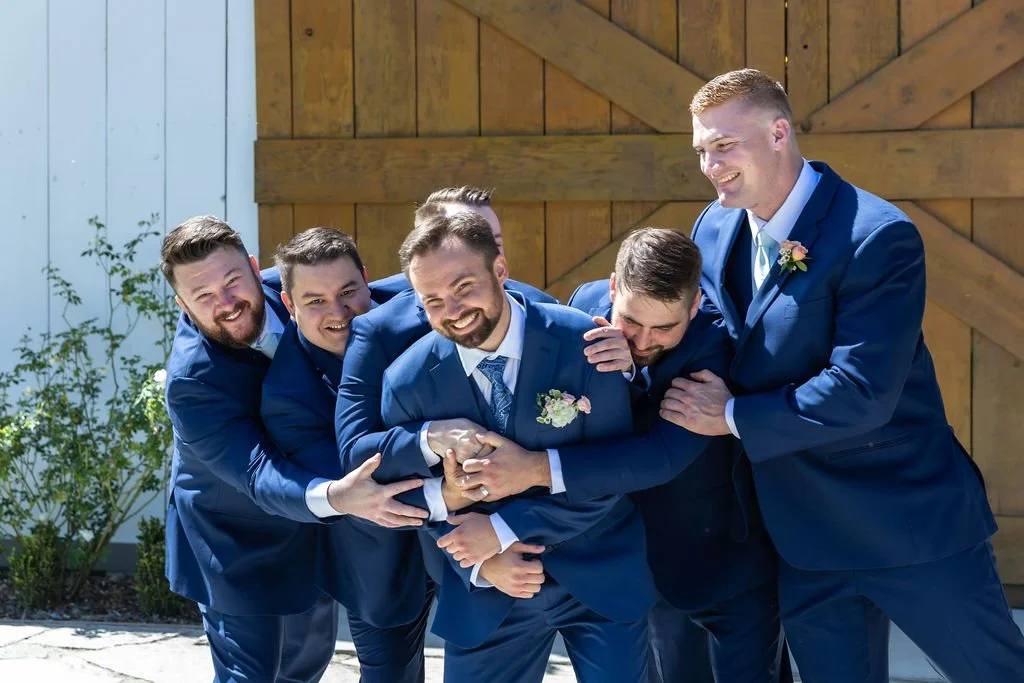 Groomsmen laughing with Clayton at a Central Coast barn wedding
