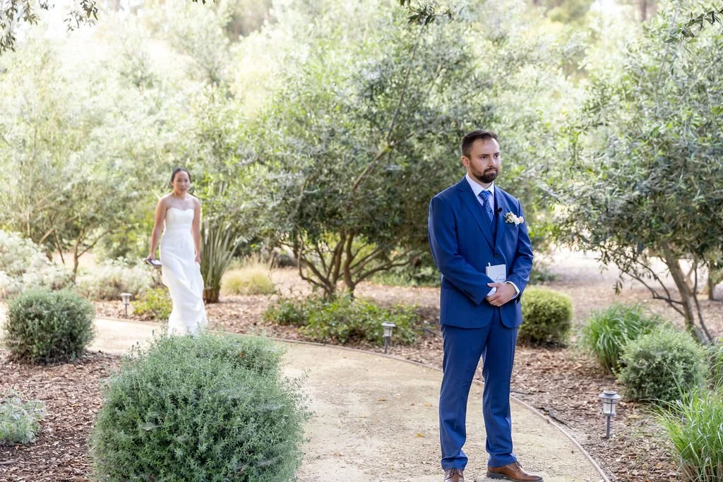 Bride approaching the groom for a first look at Tar Creek Ranch