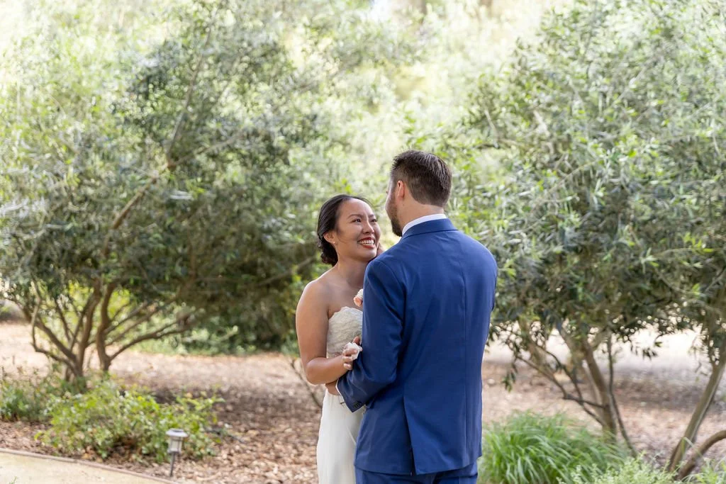 Ariana and Clayton sharing their first look among olive trees at Tar Creek Ranch