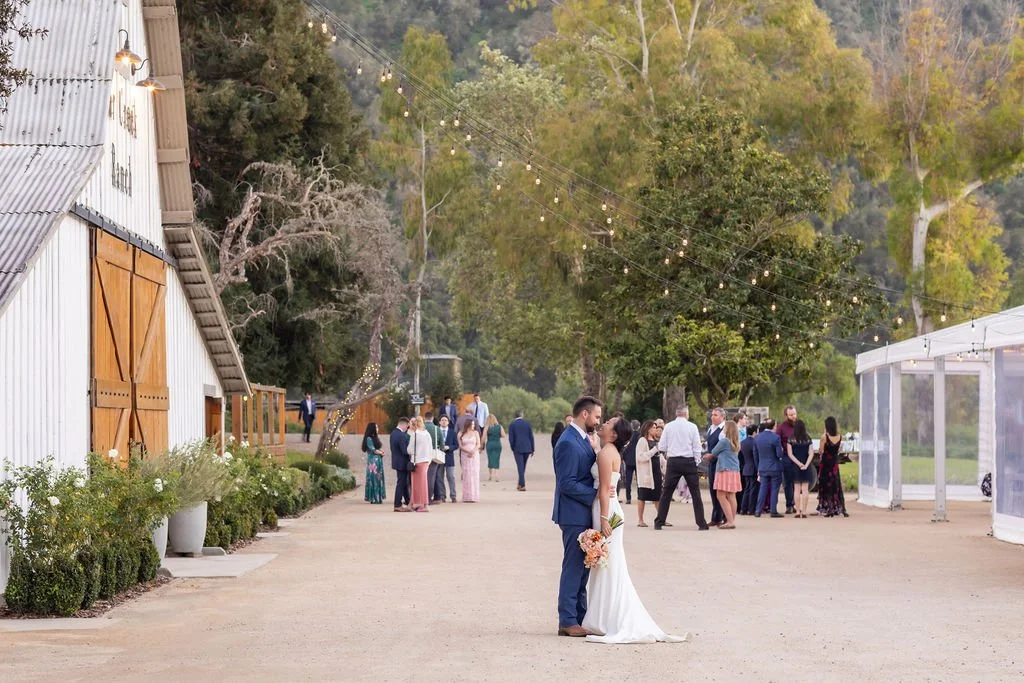 Newlyweds outside the barn and Magnolia Pavilion at Tar Creek Ranch